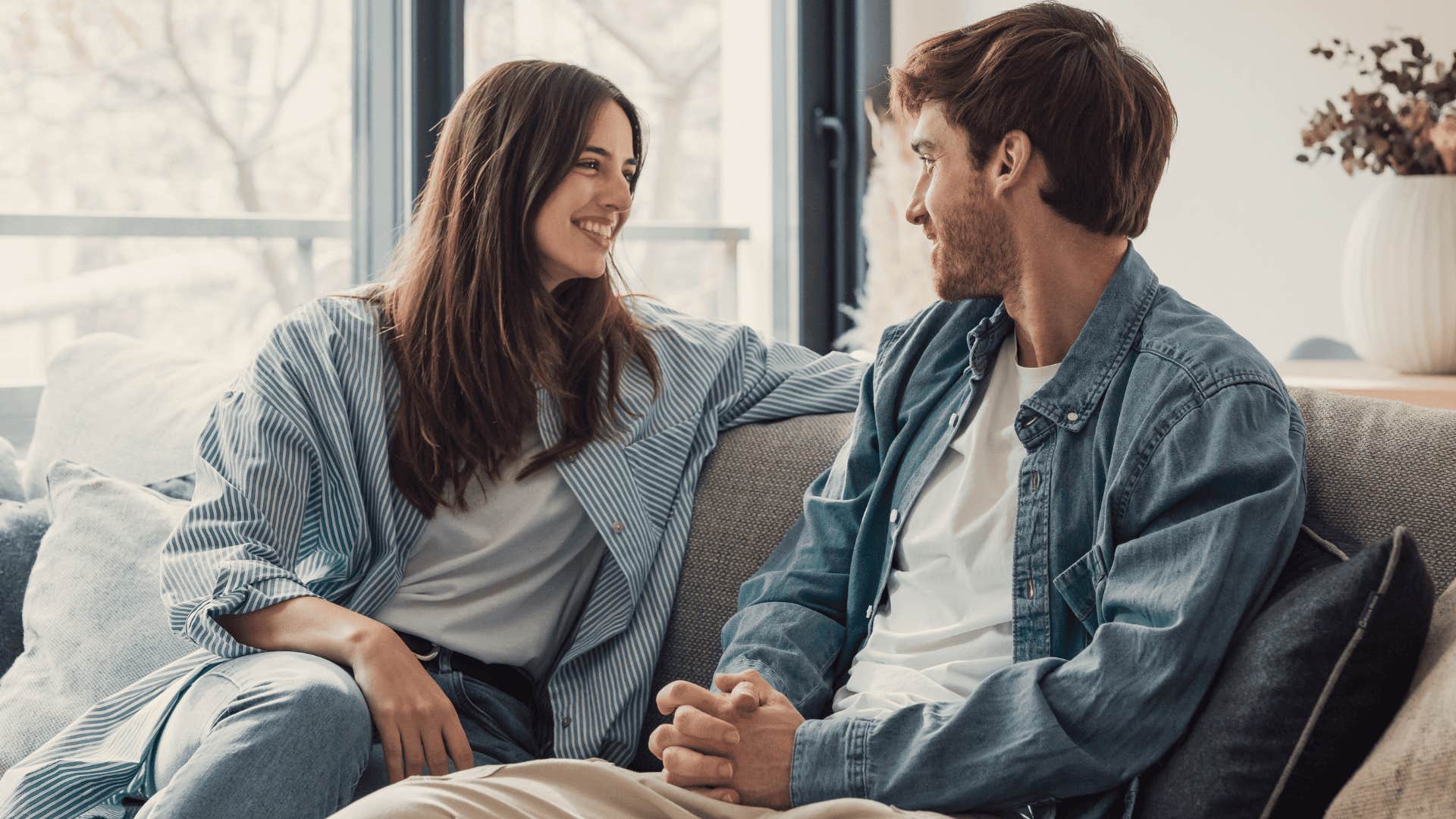 happy couple smiling on the couch