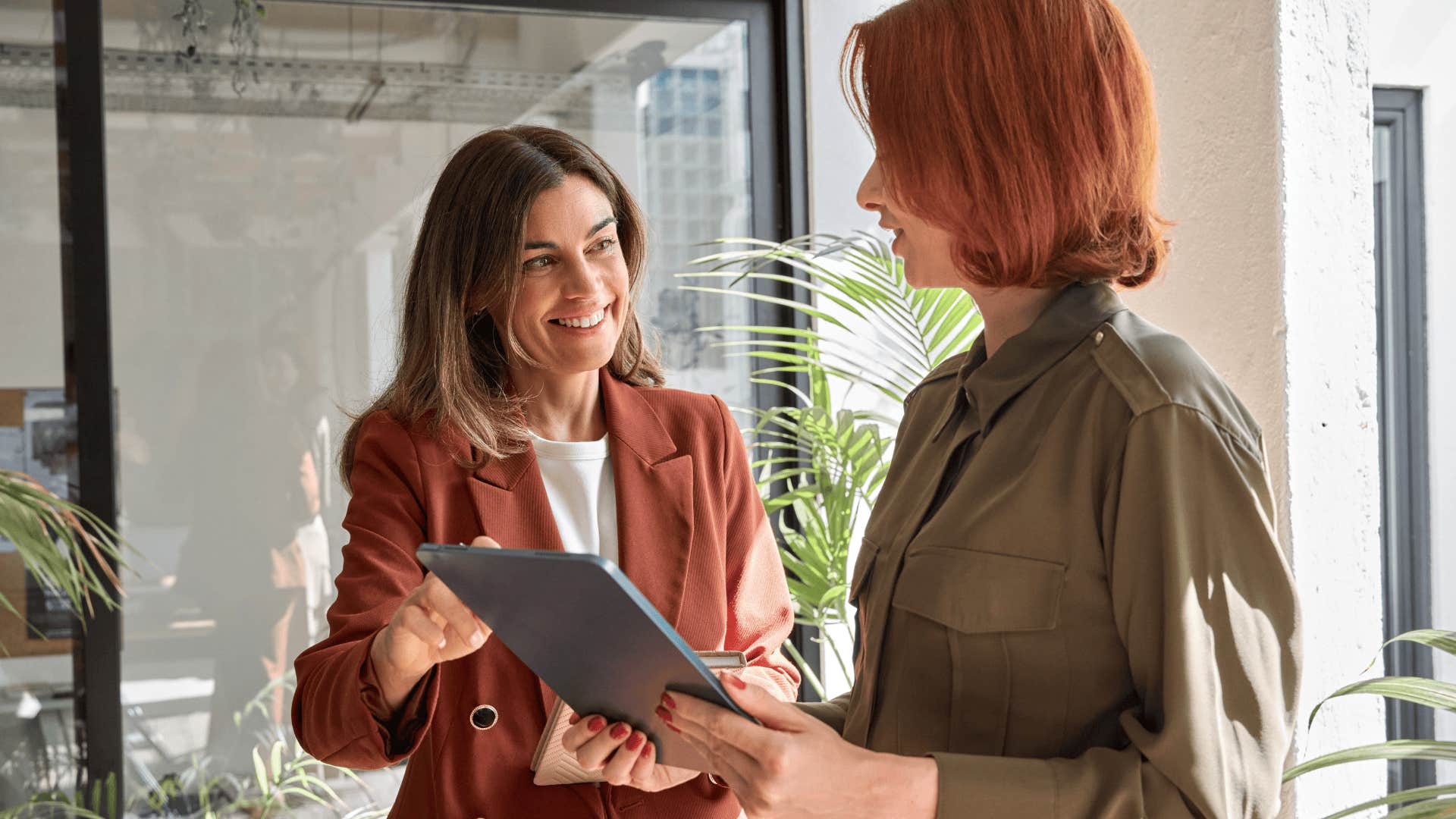 professional woman helping colleague