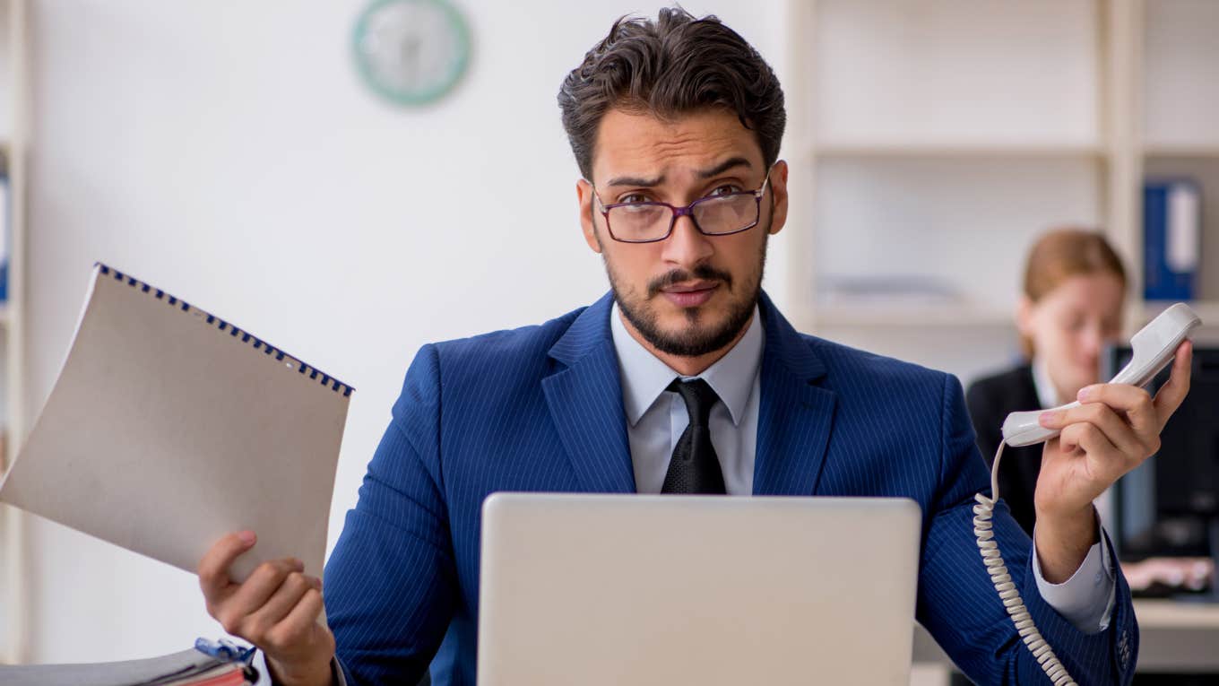 Signs You Accidentally Became Important At Work And It's Ruining Your Life busy man at work looking stressed out