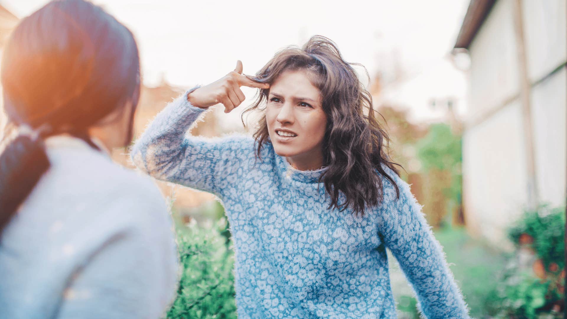 woman cursing at other woman