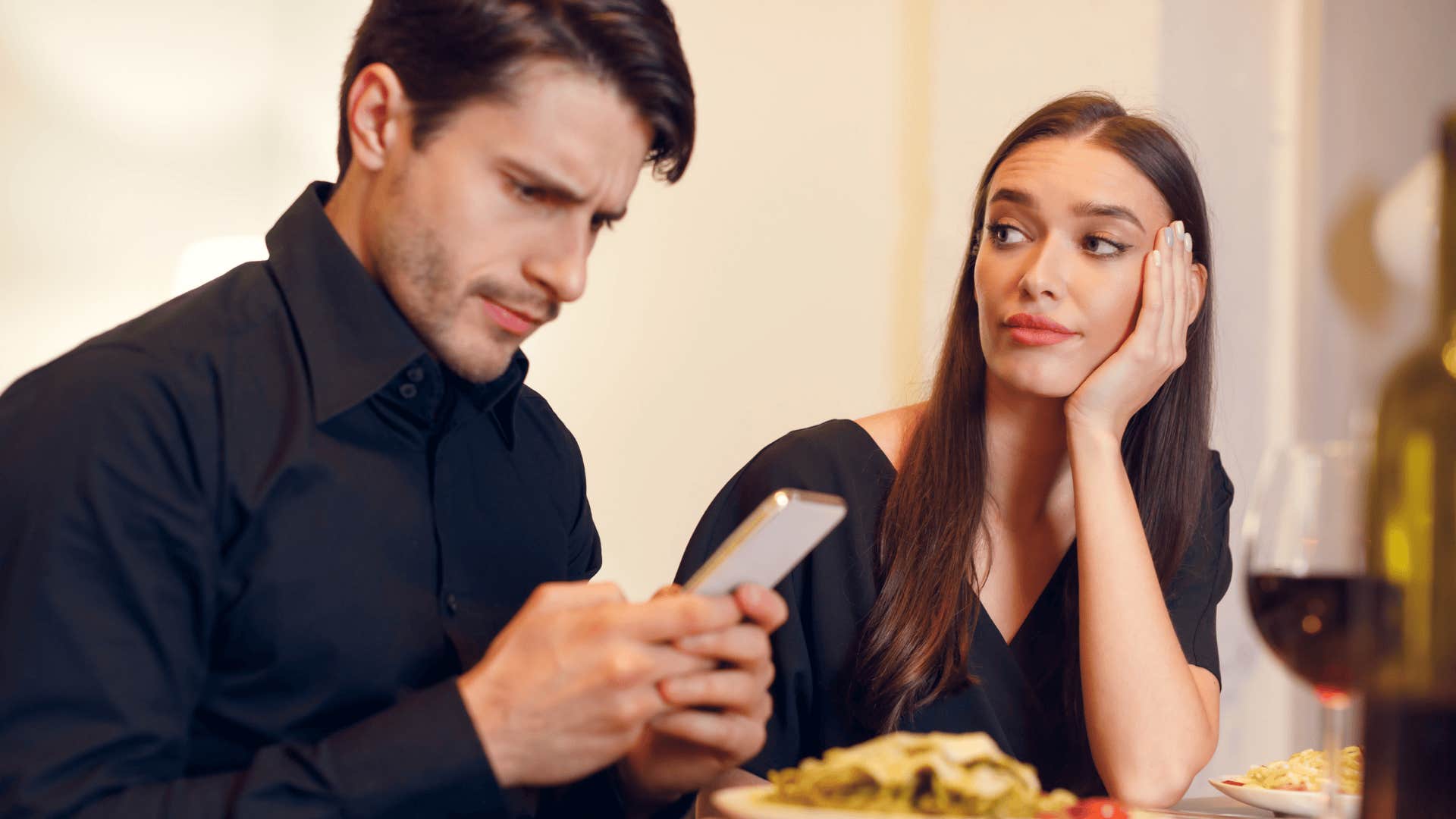 upset woman who is being breadcrumbed next to man on phone