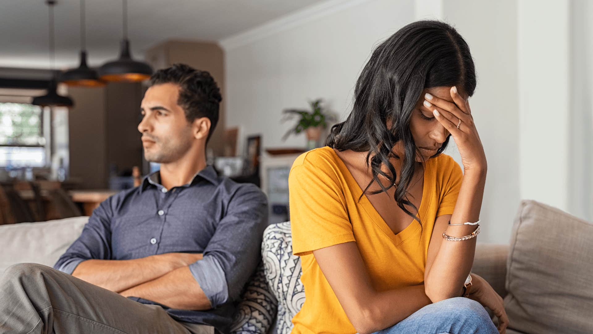 upset woman who is being breadcrumbed sitting next to man