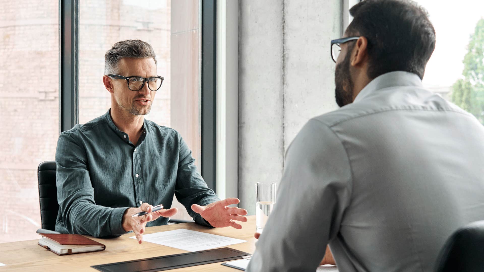 man receiving helpful criticism from co-worker