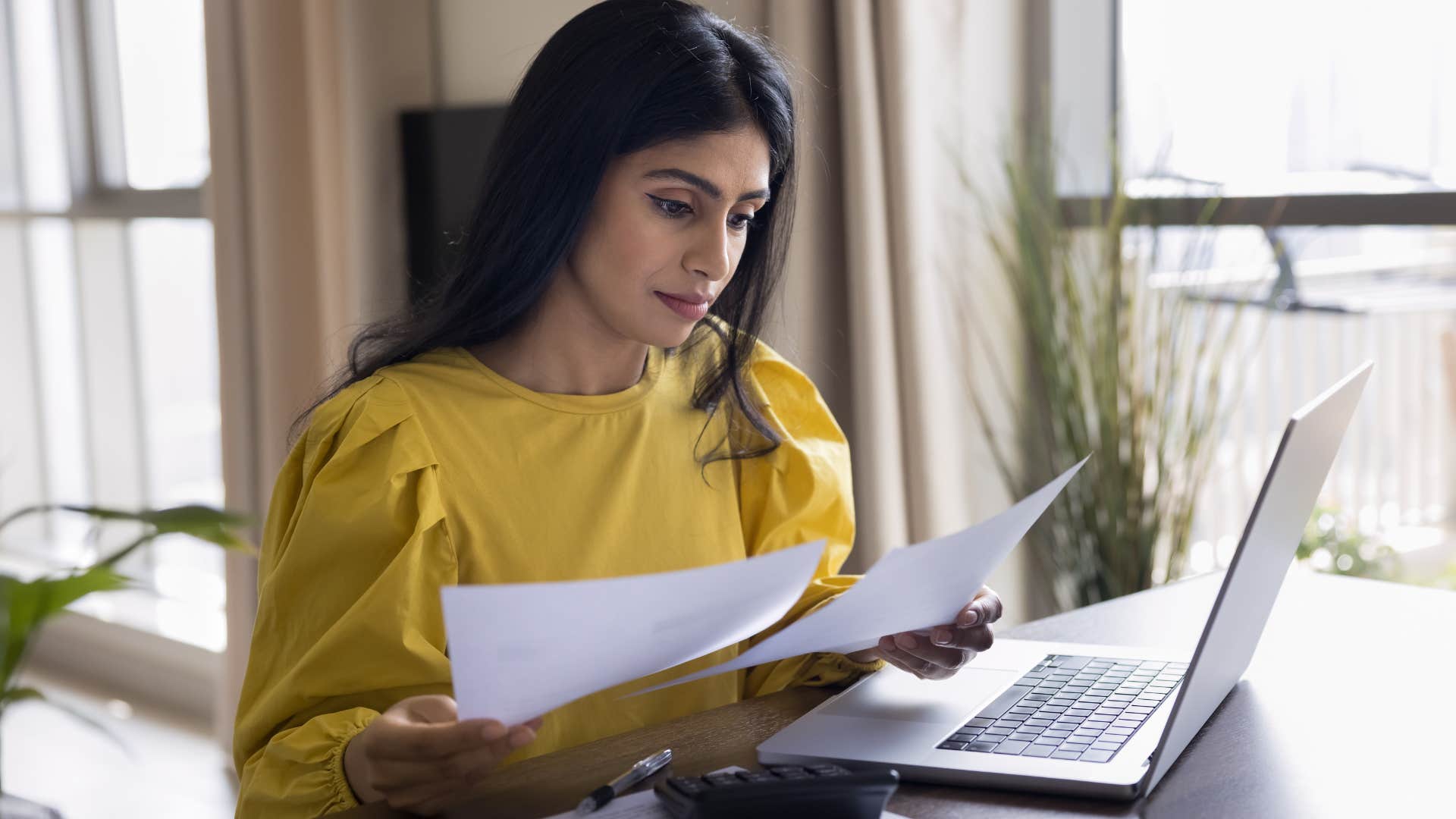 woman feeling guilty for spending money doing bills