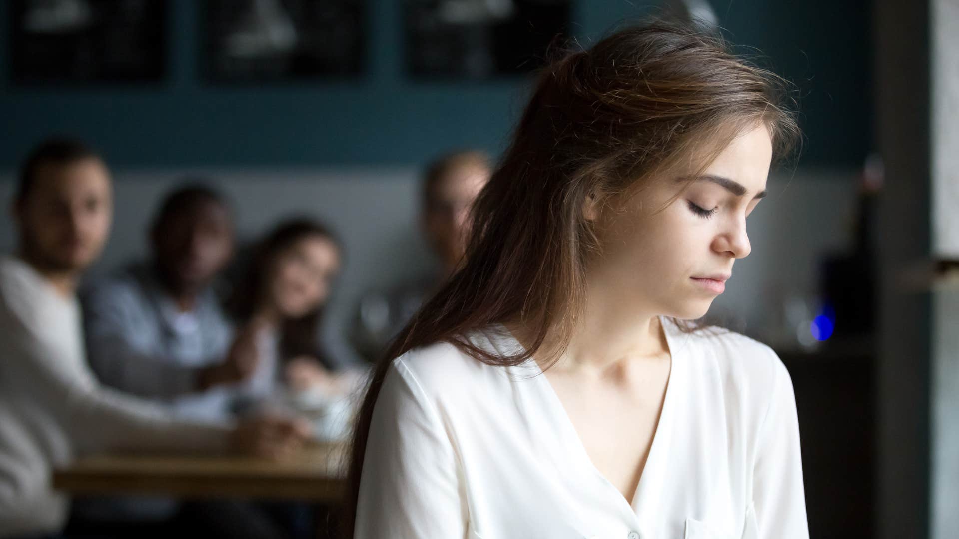 woman feels drained after talking to a group of friends