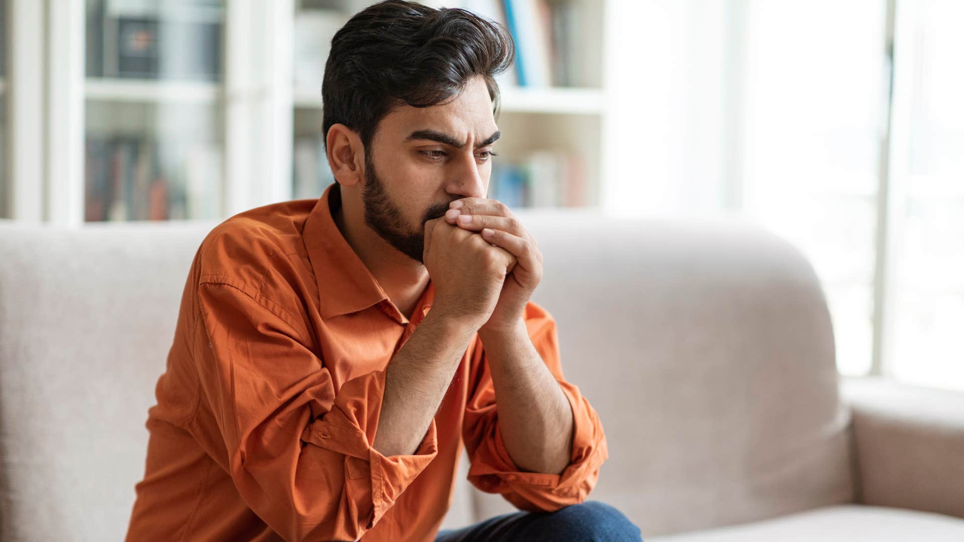 stressed man avoiding conflict sitting alone at home