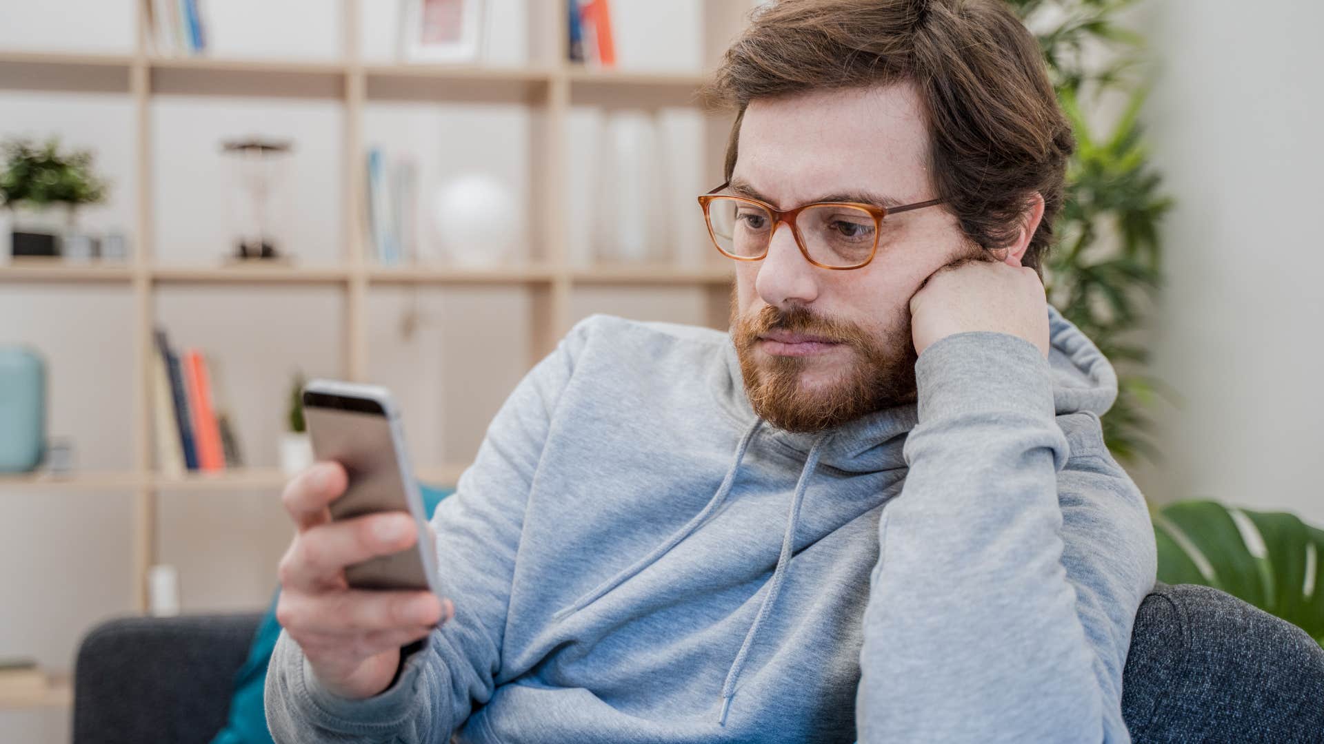 sad lonely man looking at phone