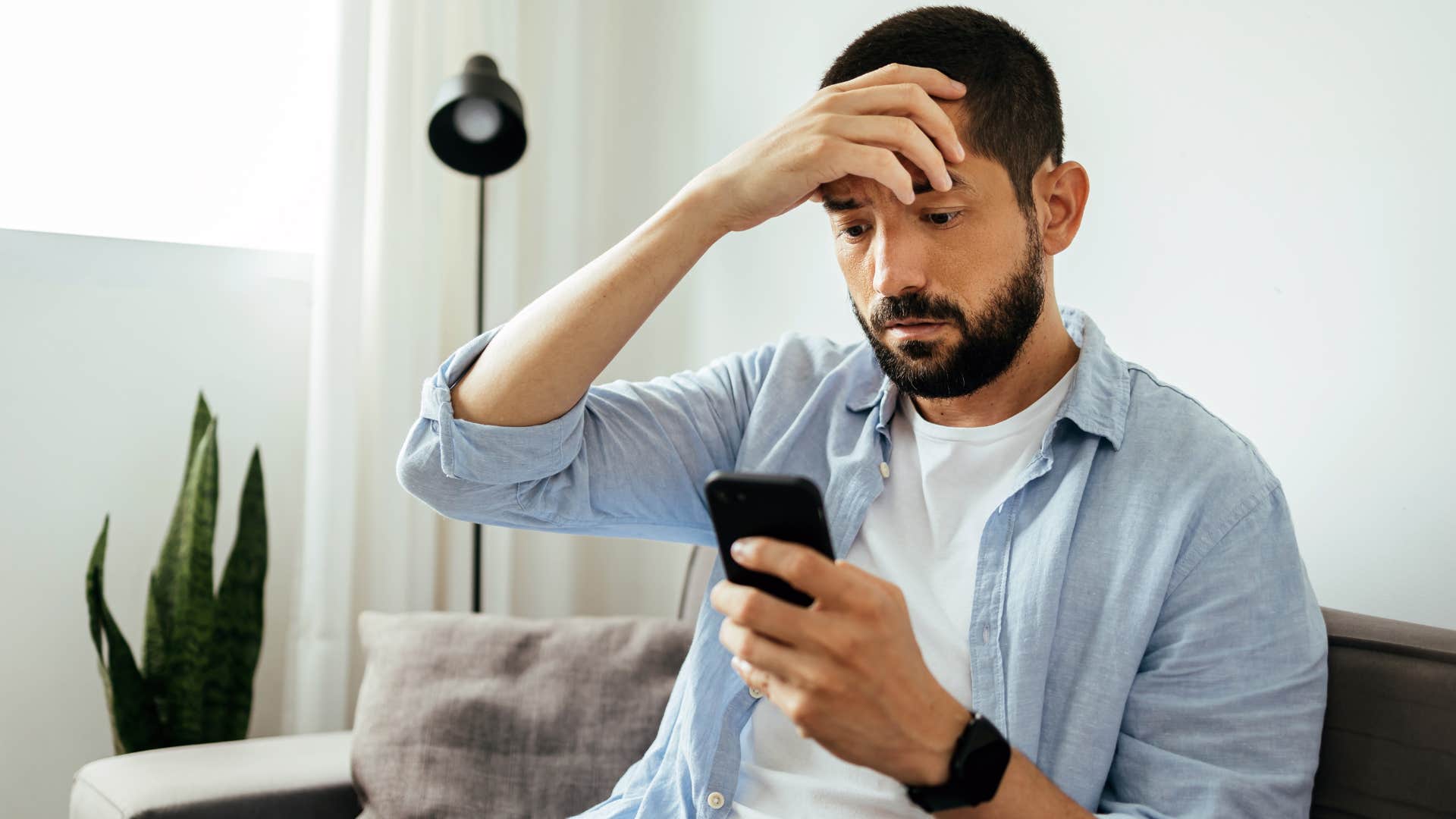 lonely man withdrawing from friends looking at phone