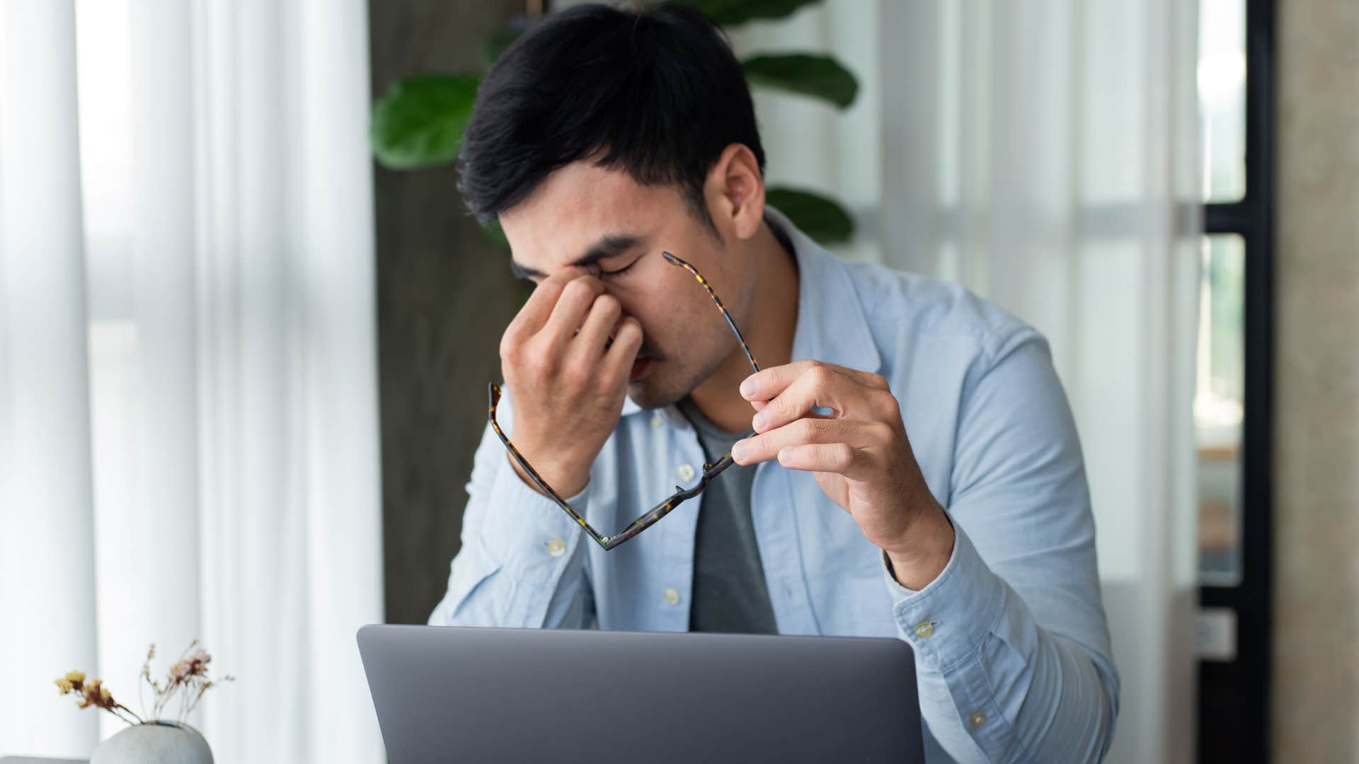 stressed out man overworking himself in an office