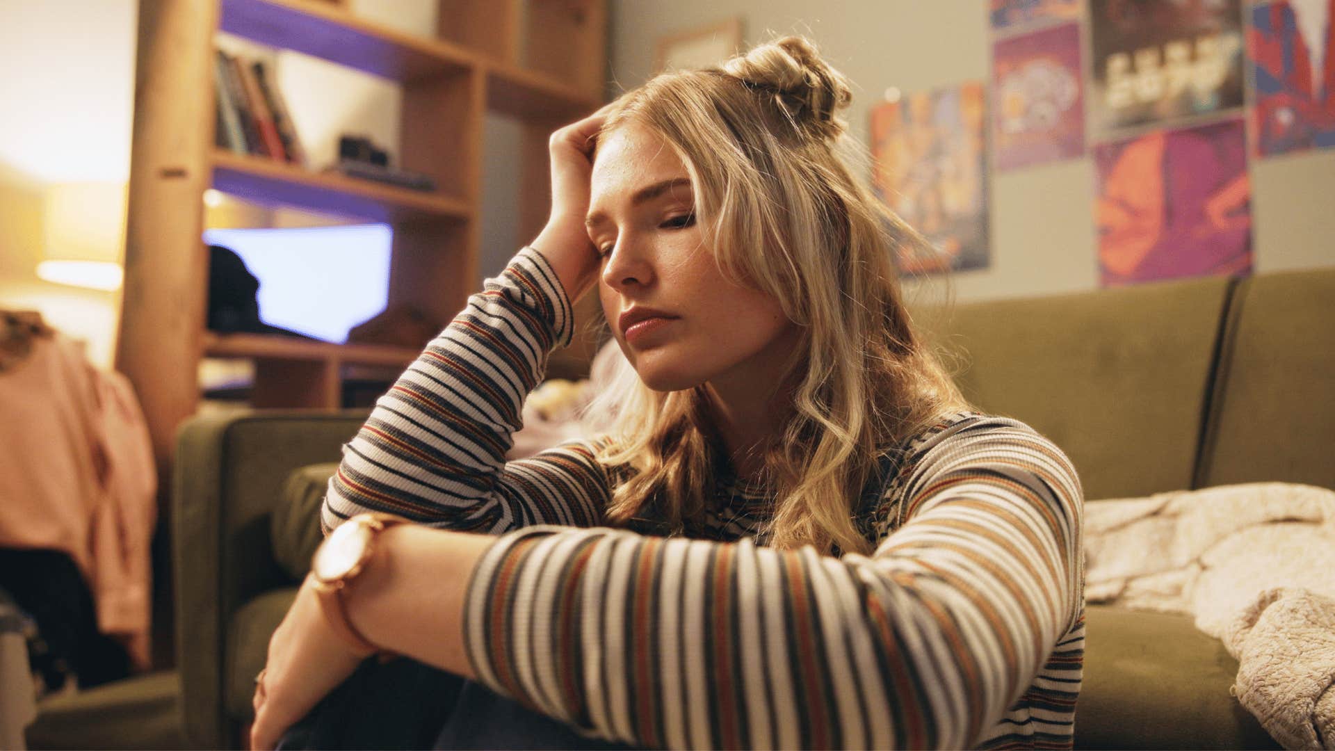 A young girl sits in her room fearing the change that is coming.