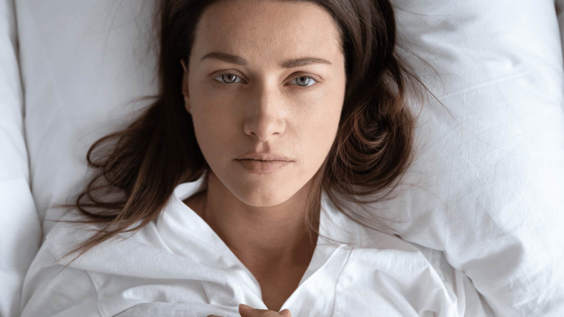 A woman lies in her bed thinking about how she has no passion or purpose.