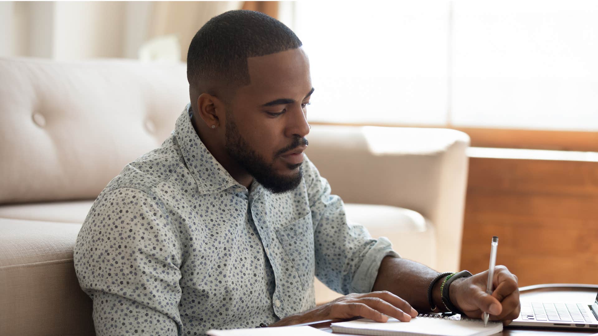 man attached to his routine writing in notebook
