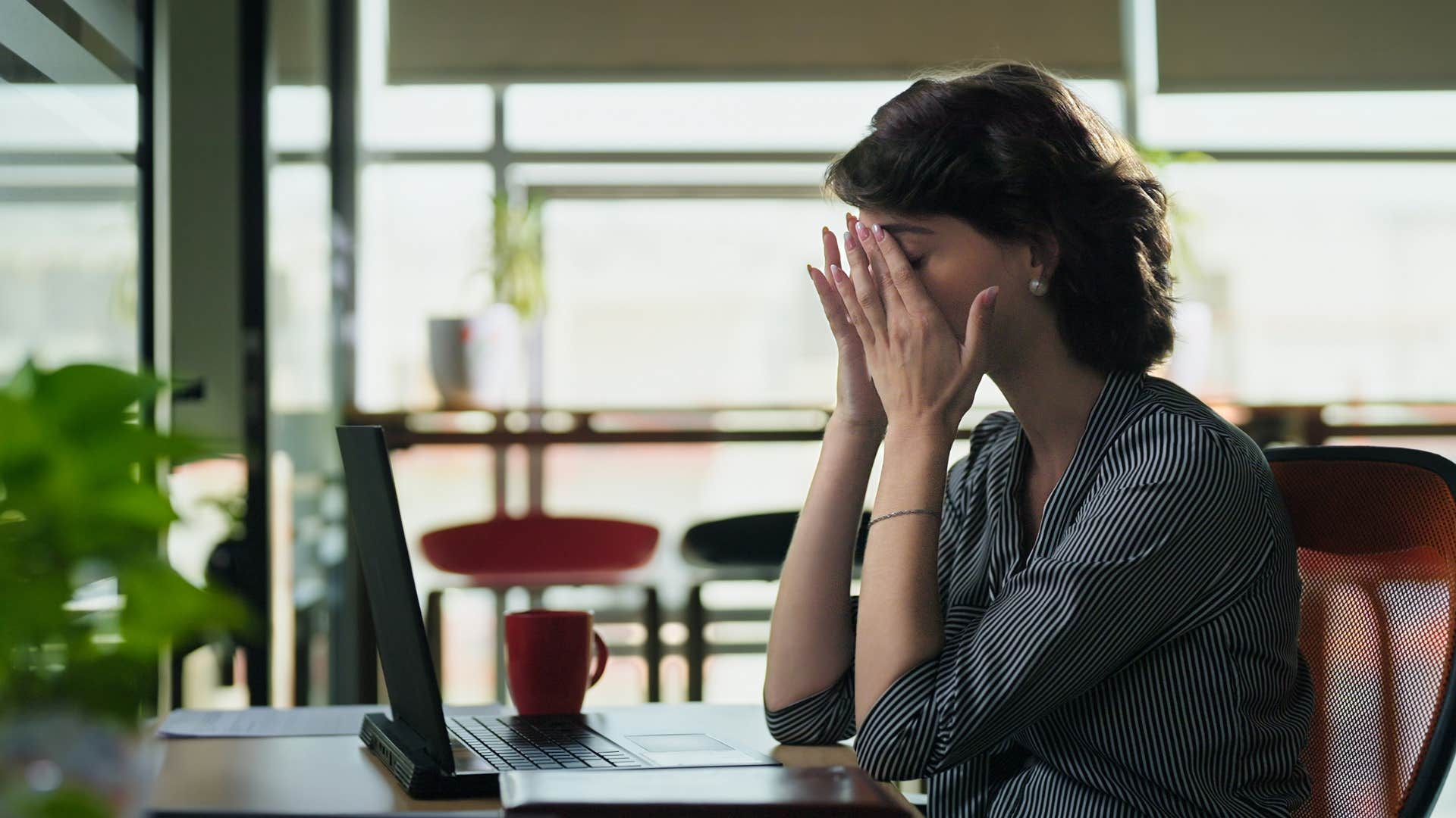 woman with low energy looking stressed while working