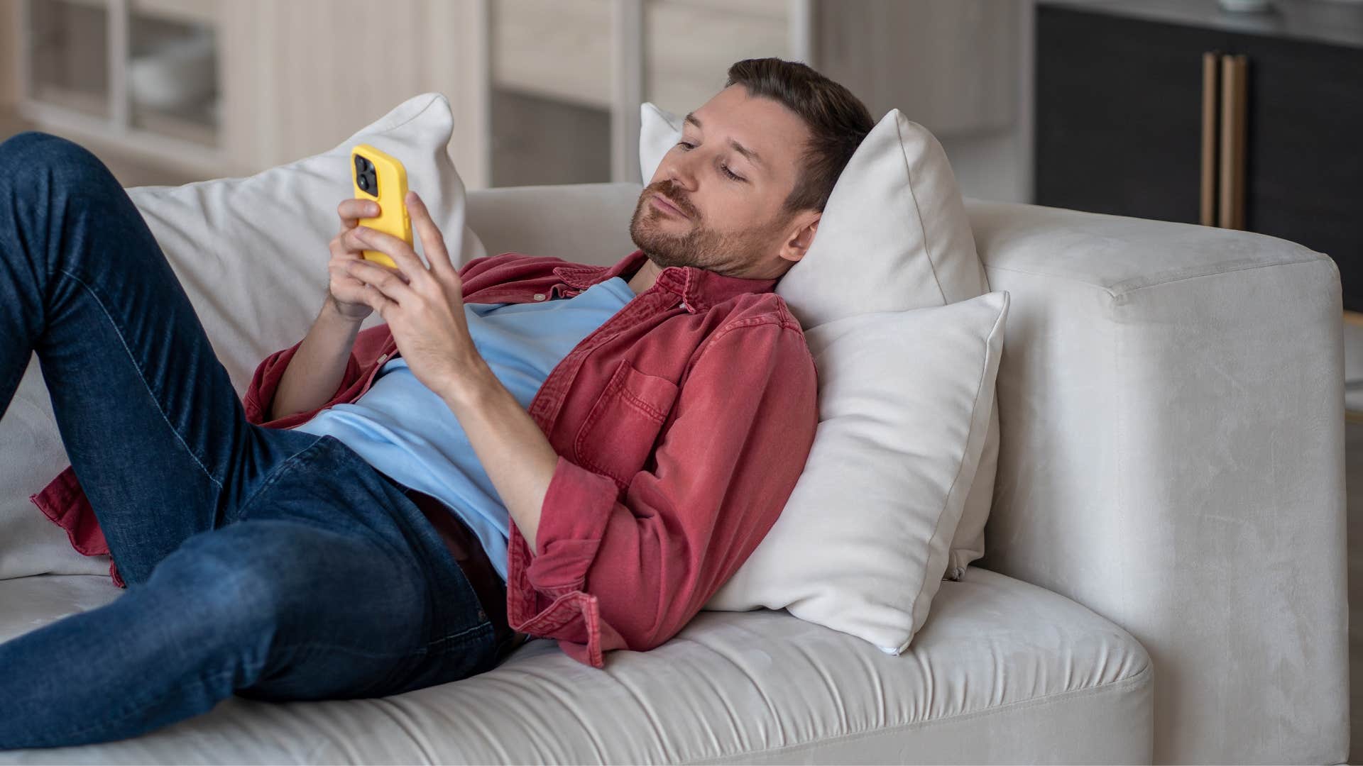 man procrastinating on his phone