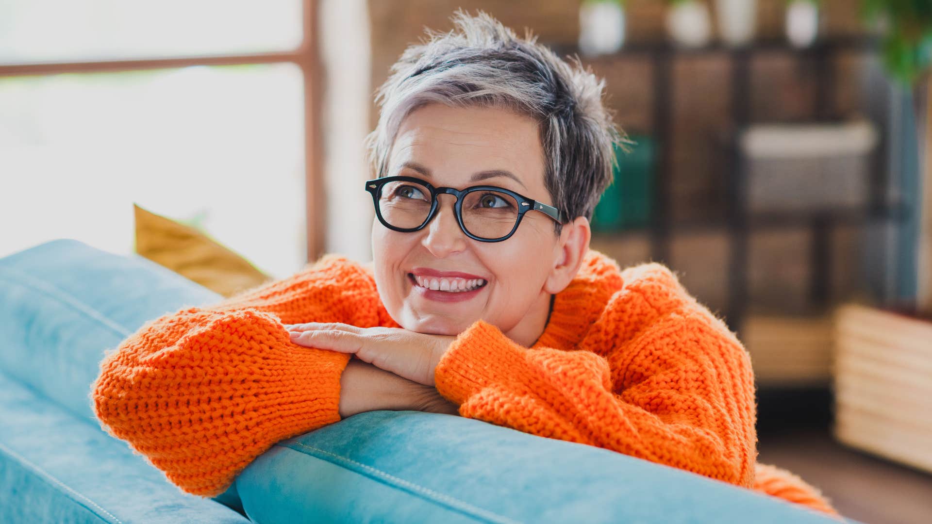 woman leaning on couch as she reminisces about the past