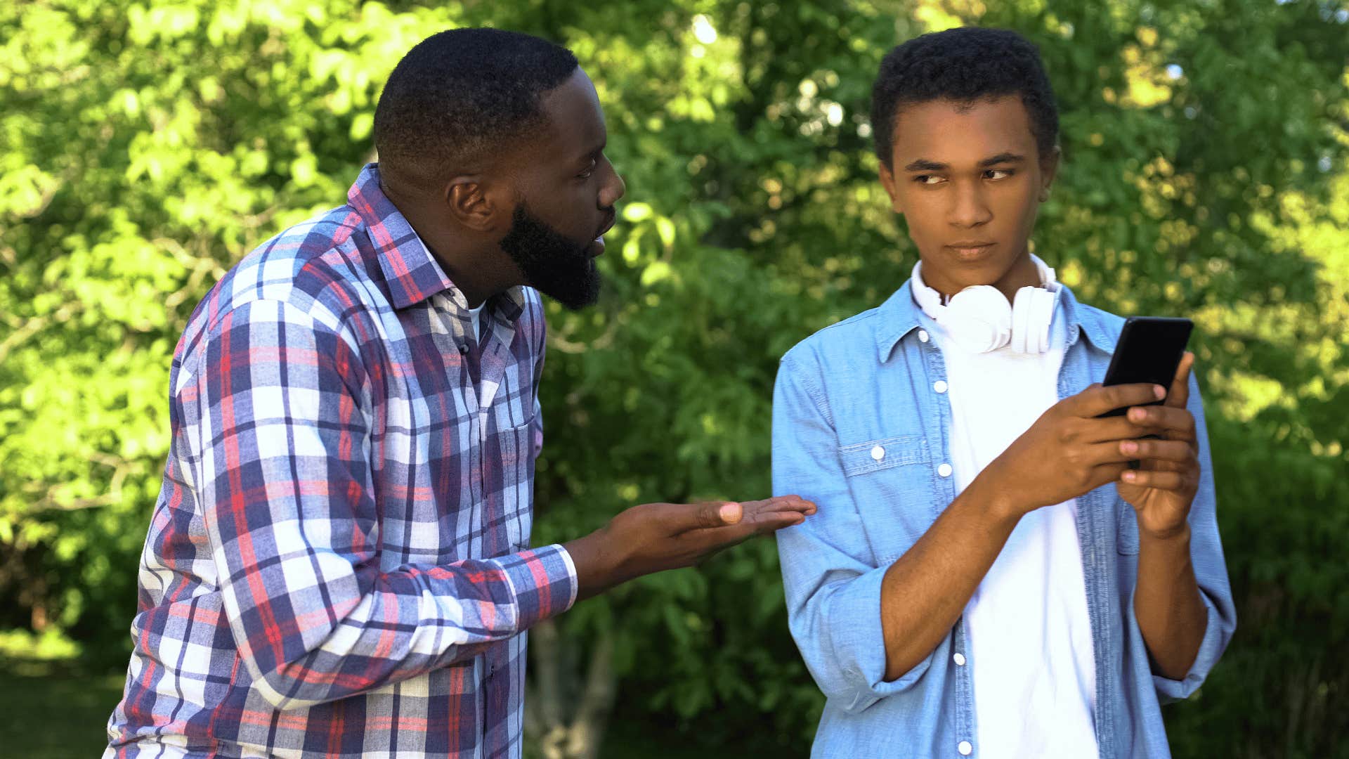 young man ignoring father and refusing to ask about his health
