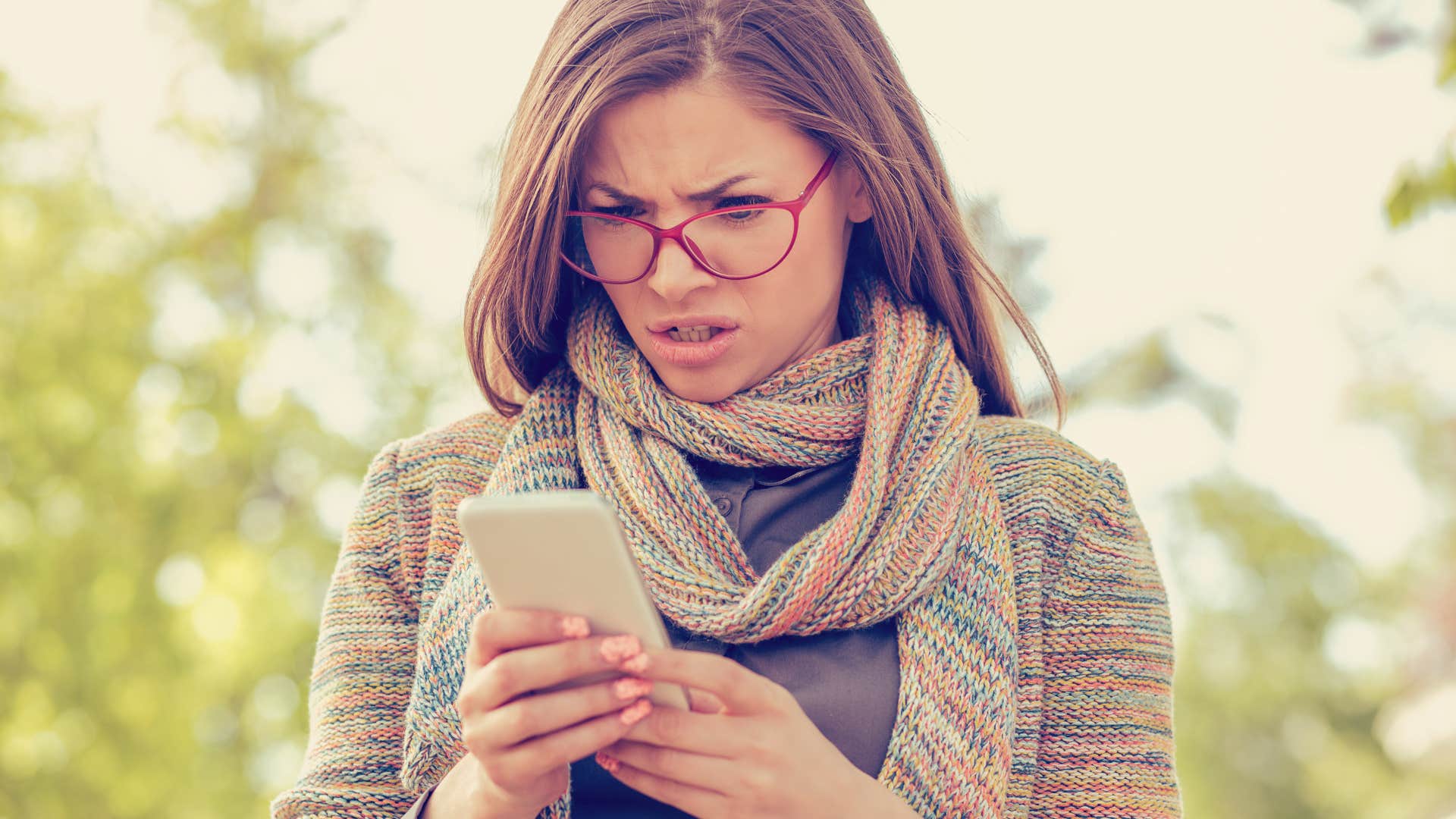 woman reading text excluding her from event