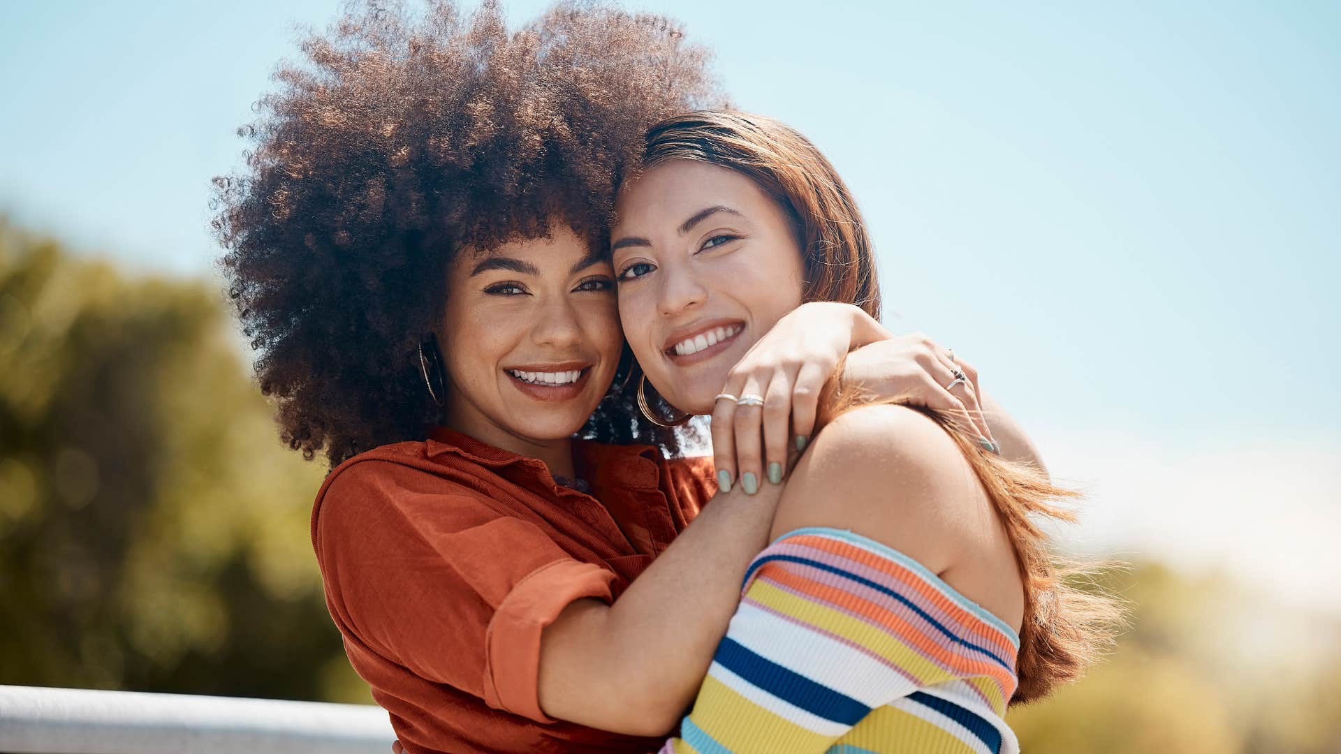 two female friends hugging smiling