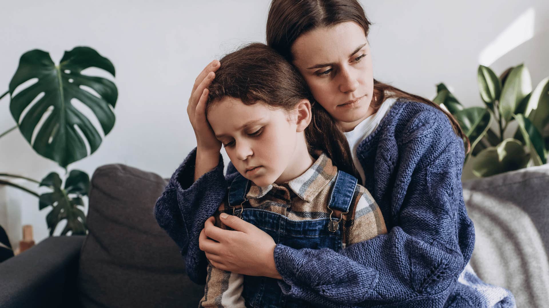 A mother cradles her daughter after telling her about her trauma and using her as a therapist.