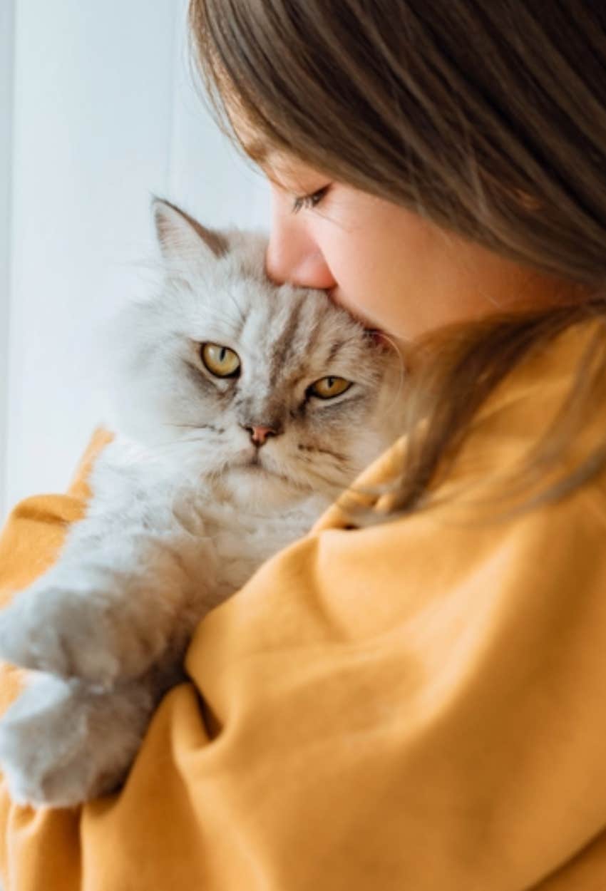 woman and new pet cat that was sent to her by her pet that passed away