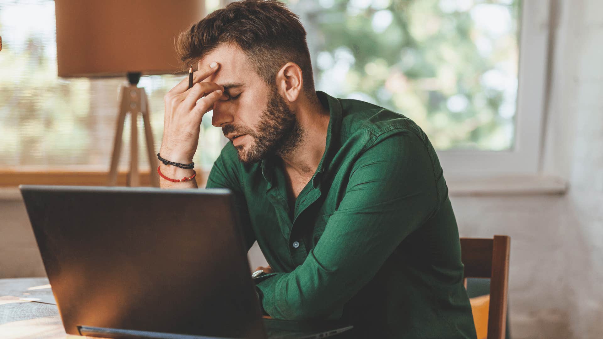 man upset because his boss is micromanaging him at work