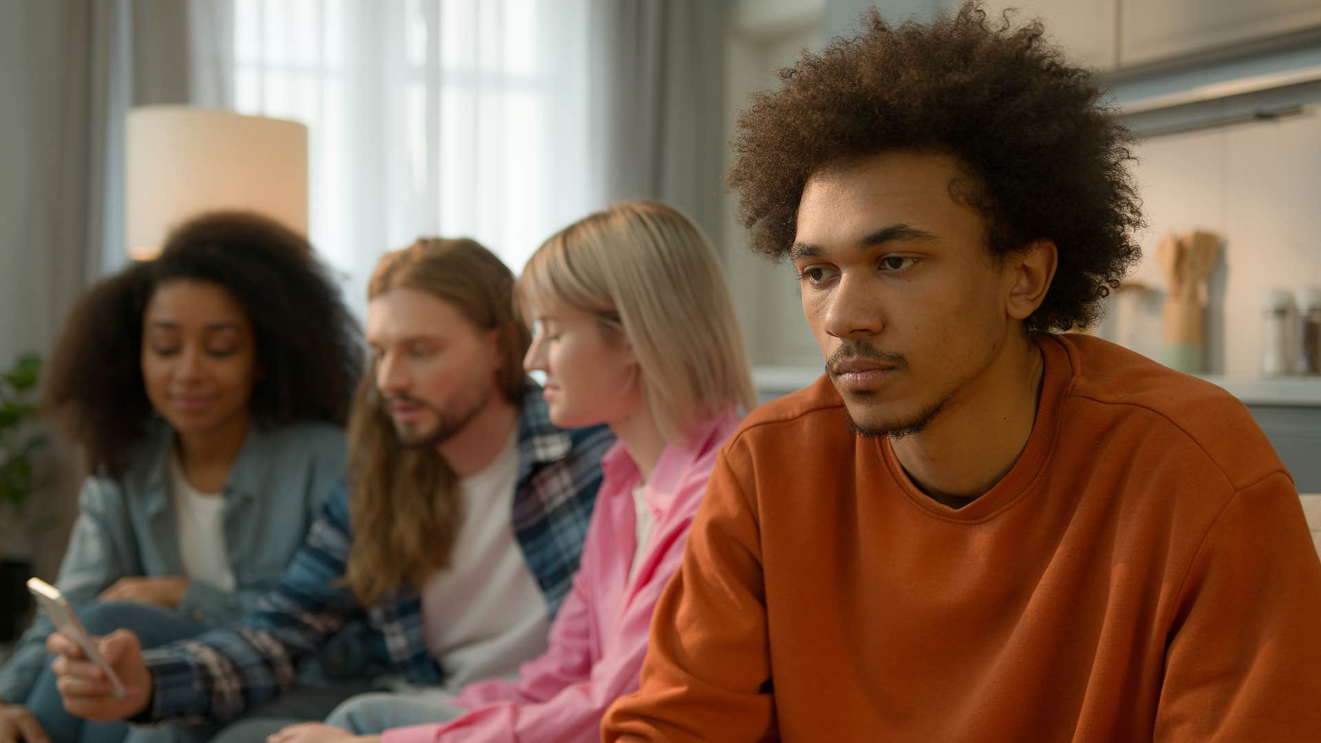 man zoning out and not listening to his friends conversation