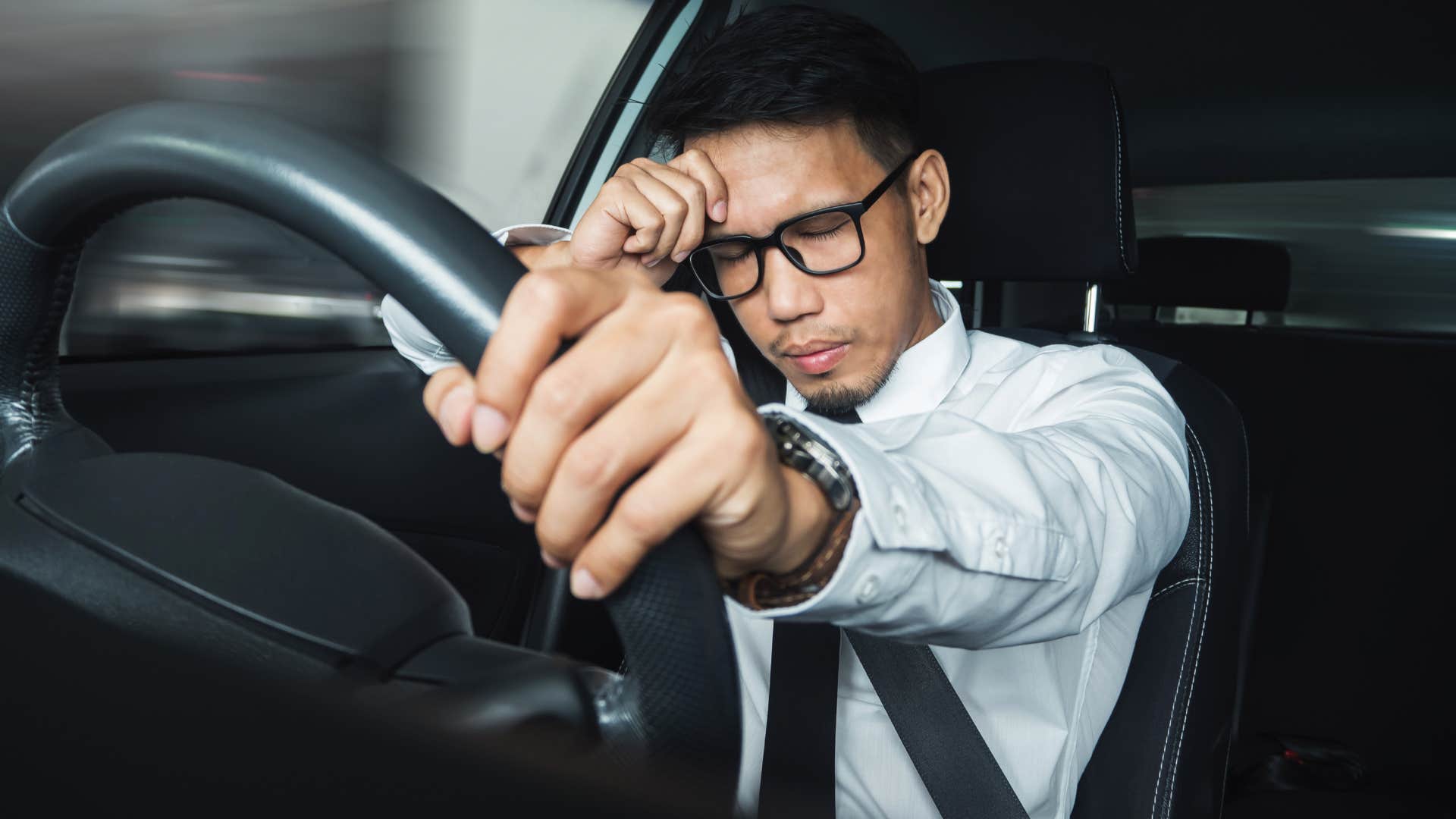 stressed man holding his forehead in commute to work