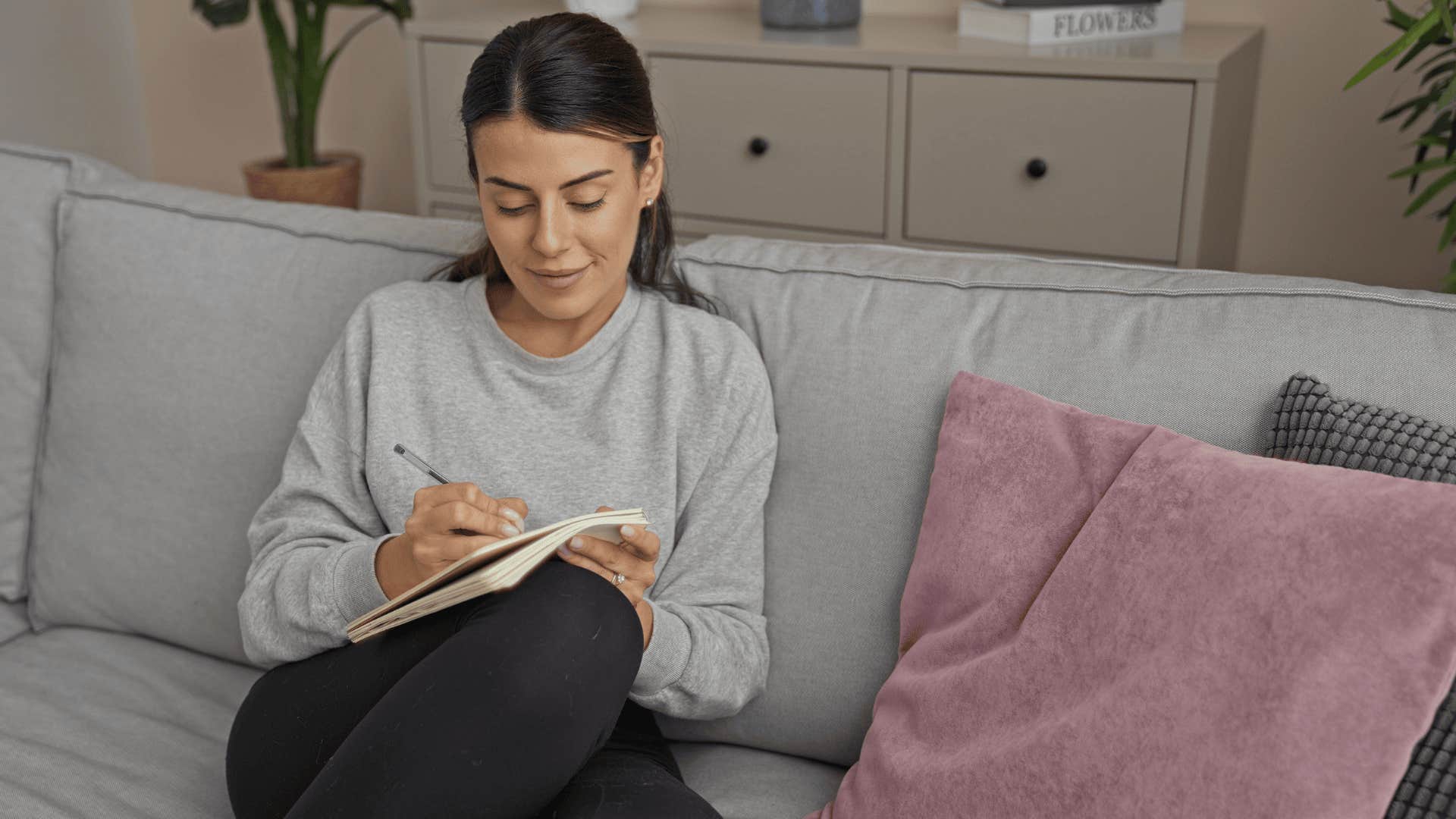woman who figured out simple life hacks writing in journal