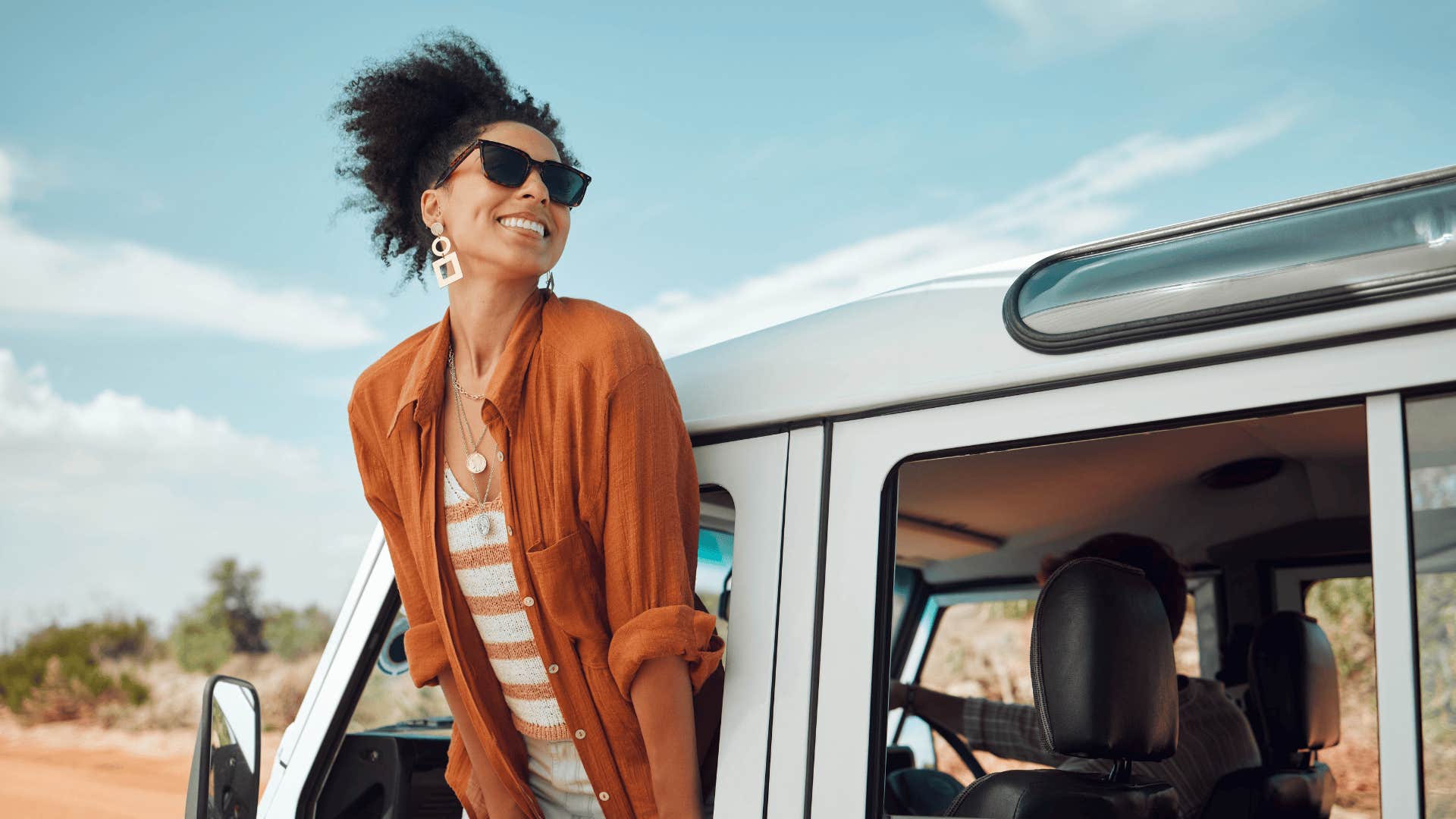woman who knows simple life hacks smiling outside car window 