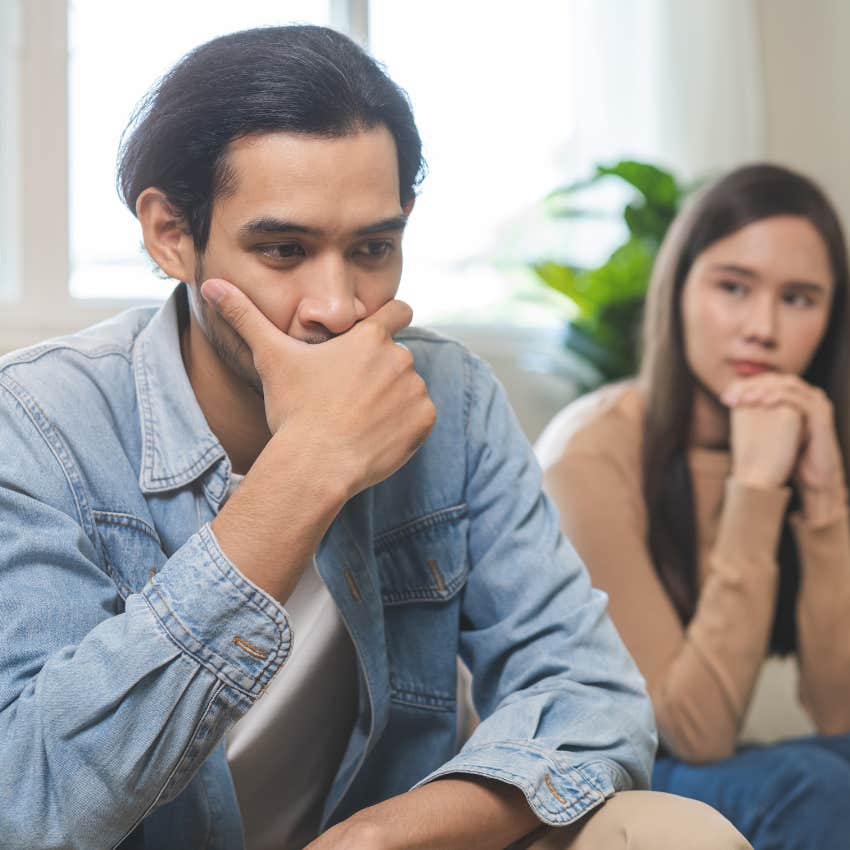 deeply unhappy man sitting next to woman
