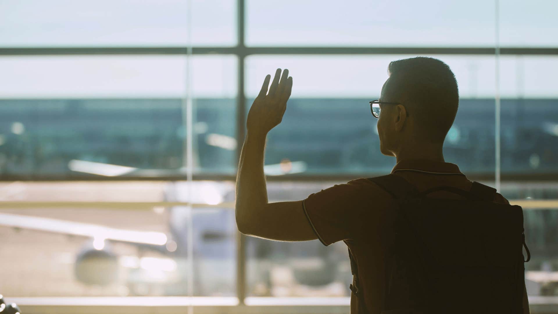 man waving goodbye after listening to So Long London