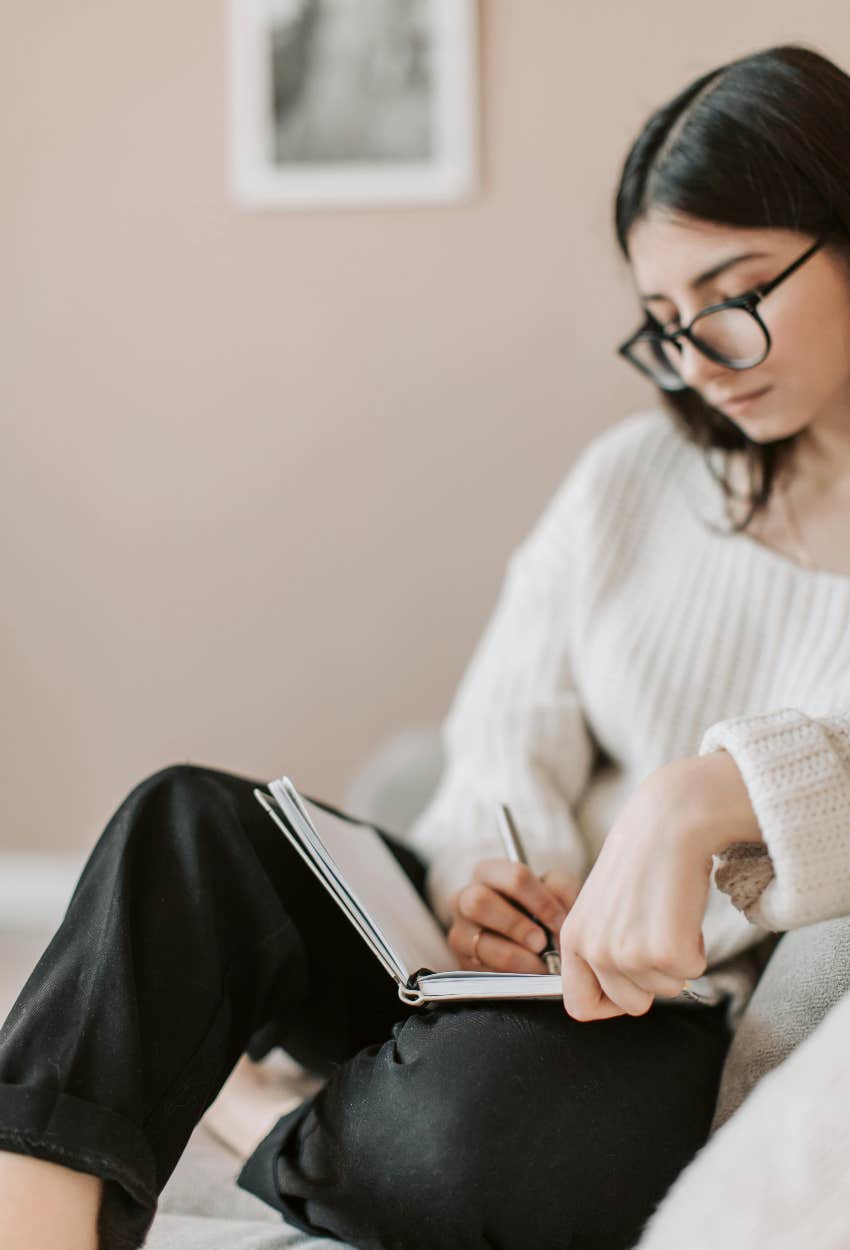 woman who is journaling about her manifestation that is taking long