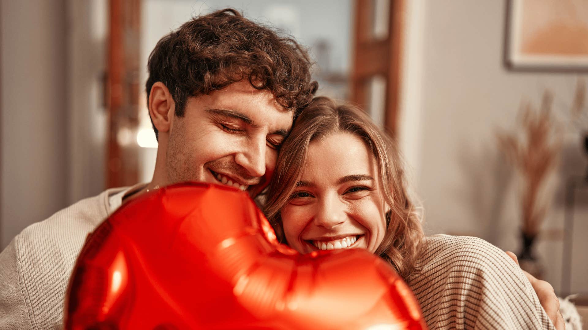 smiling man with strange behaviors with woman holding balloon