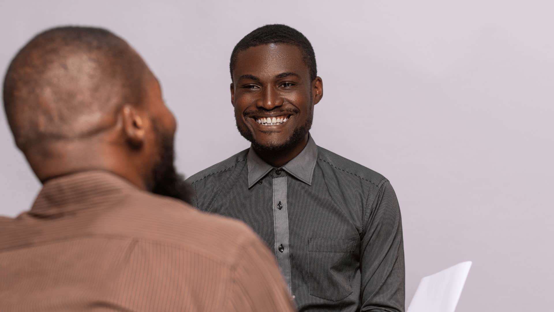 man who everyone respects smiling and listening 