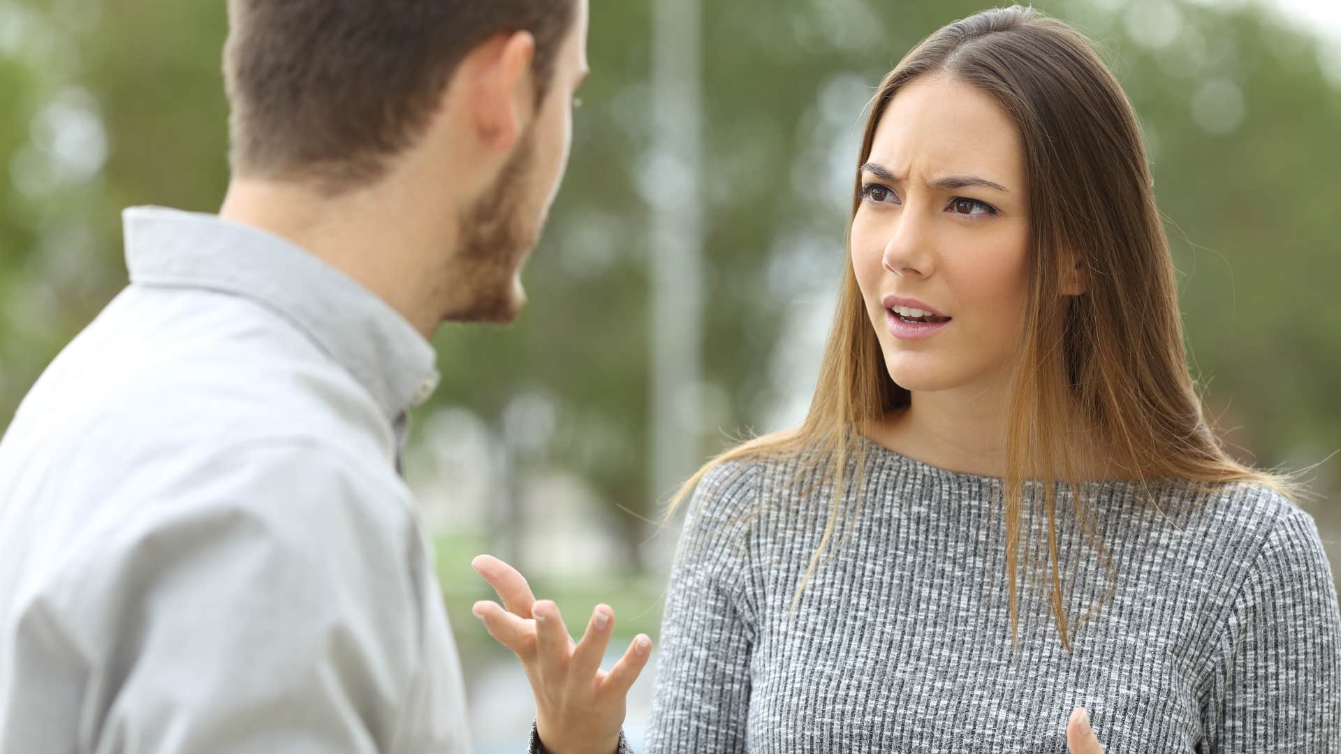 woman arguing with man who told her she should smile more