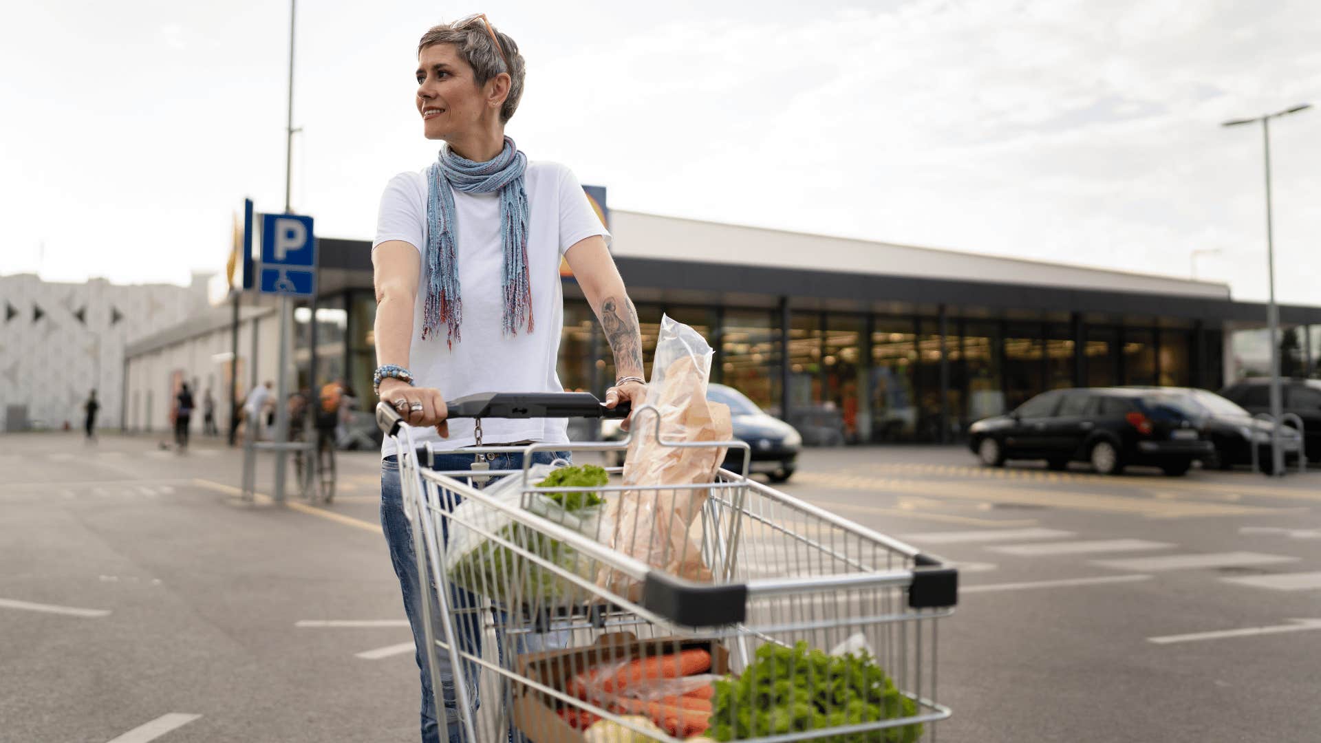 woman walking with shopping cart 