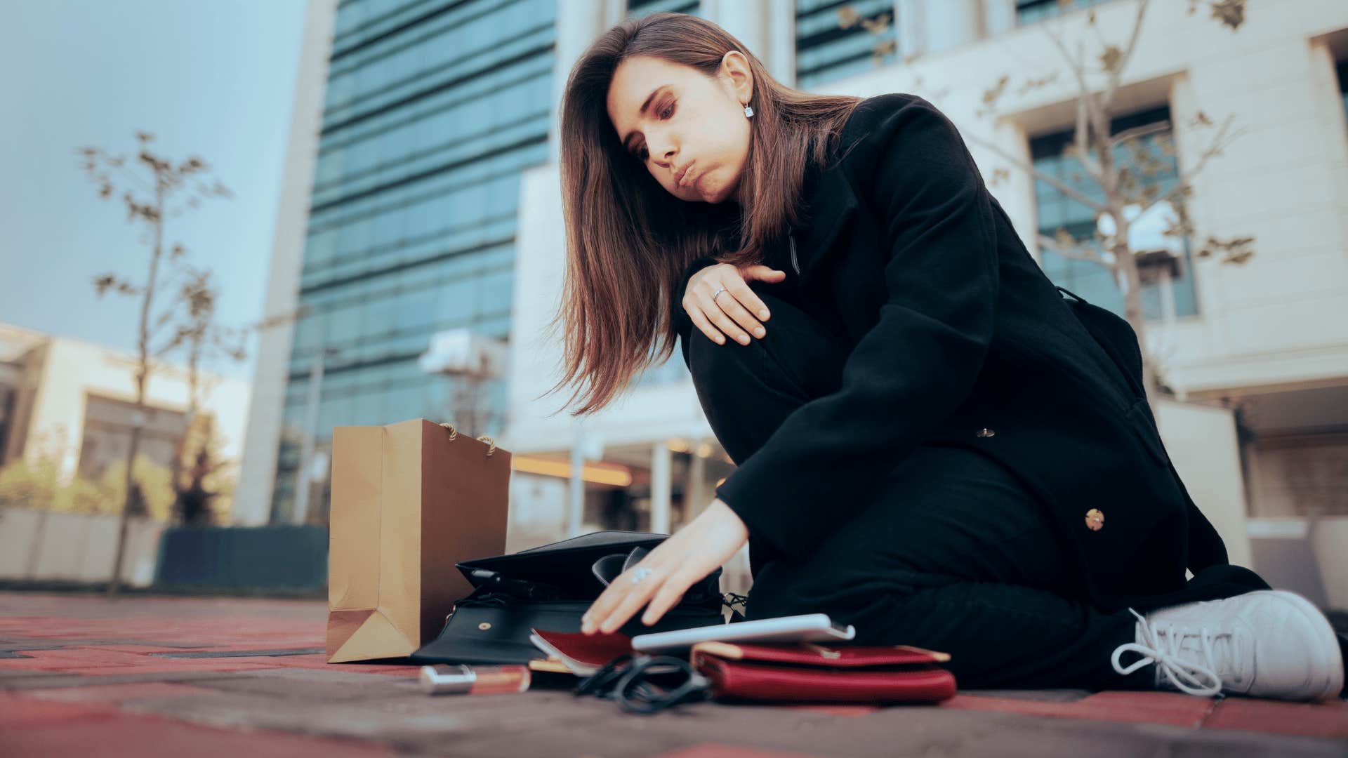 woman picking up items after being bumped into