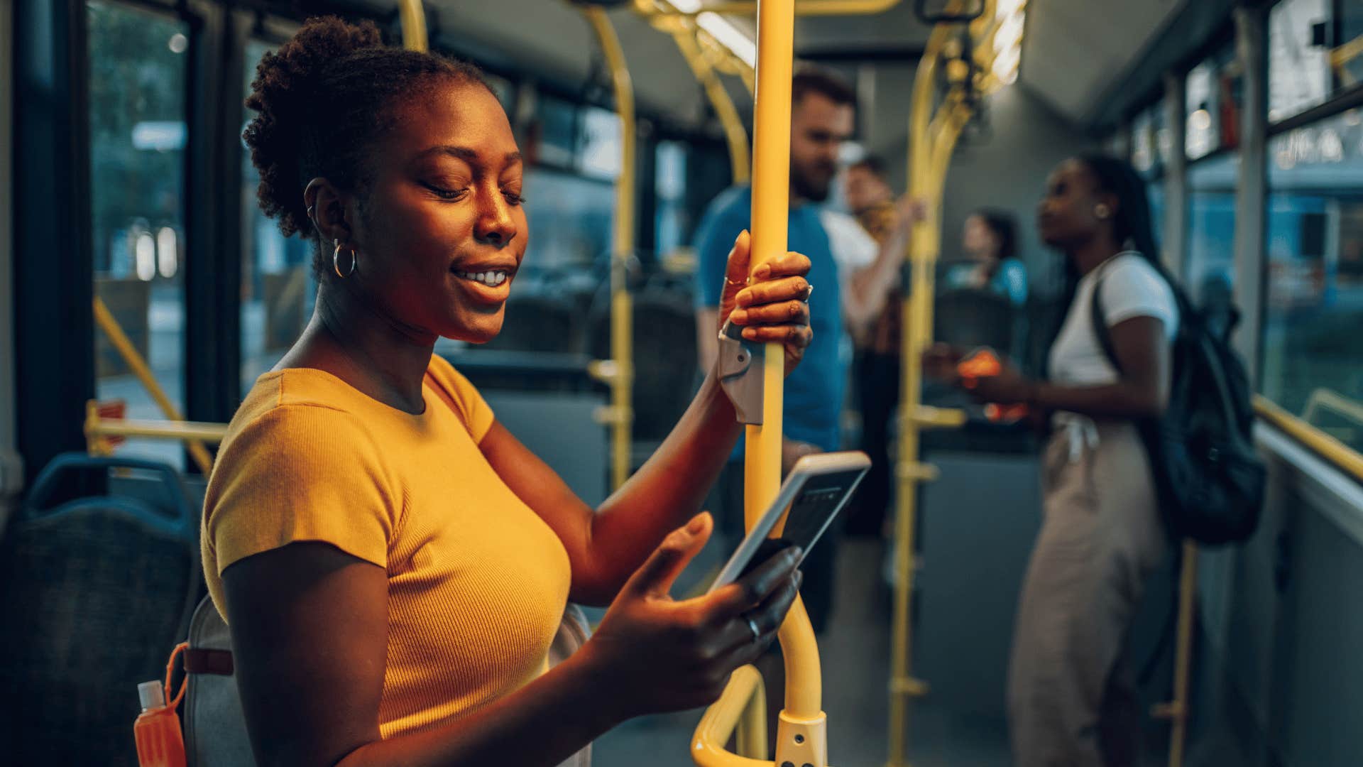 woman on her phone on public bus