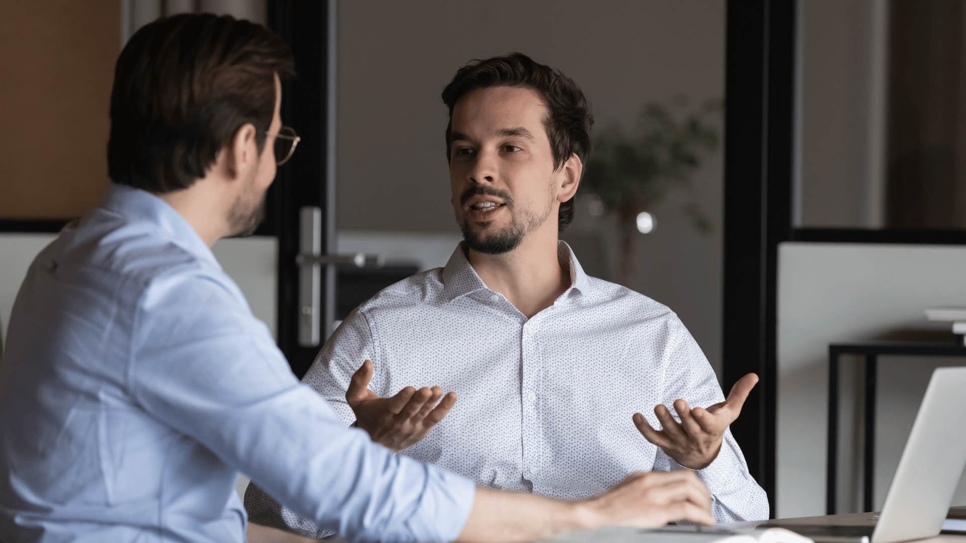 man talking over co-worker not allowing him to speak