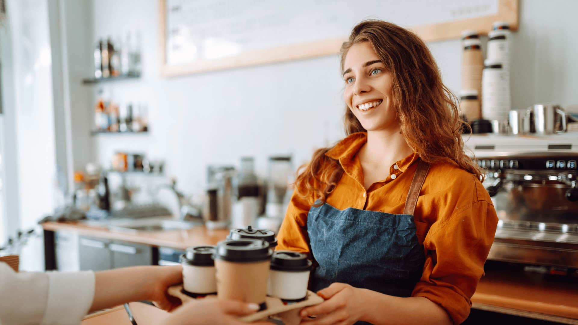 barista handing out coffees