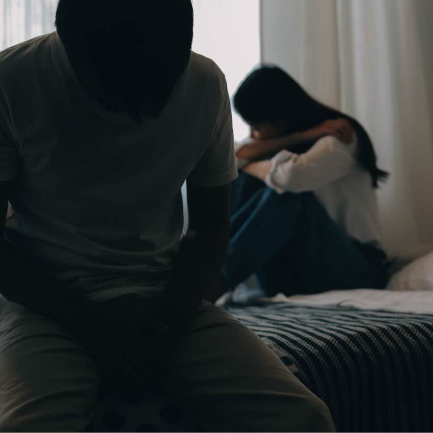 upset woman in an emotionally abusive relationship behind man