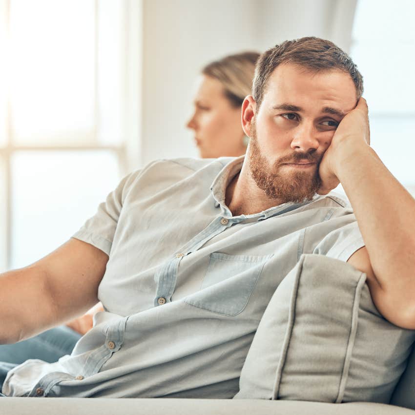 upset woman in an emotionally abusive relationship sitting next to man