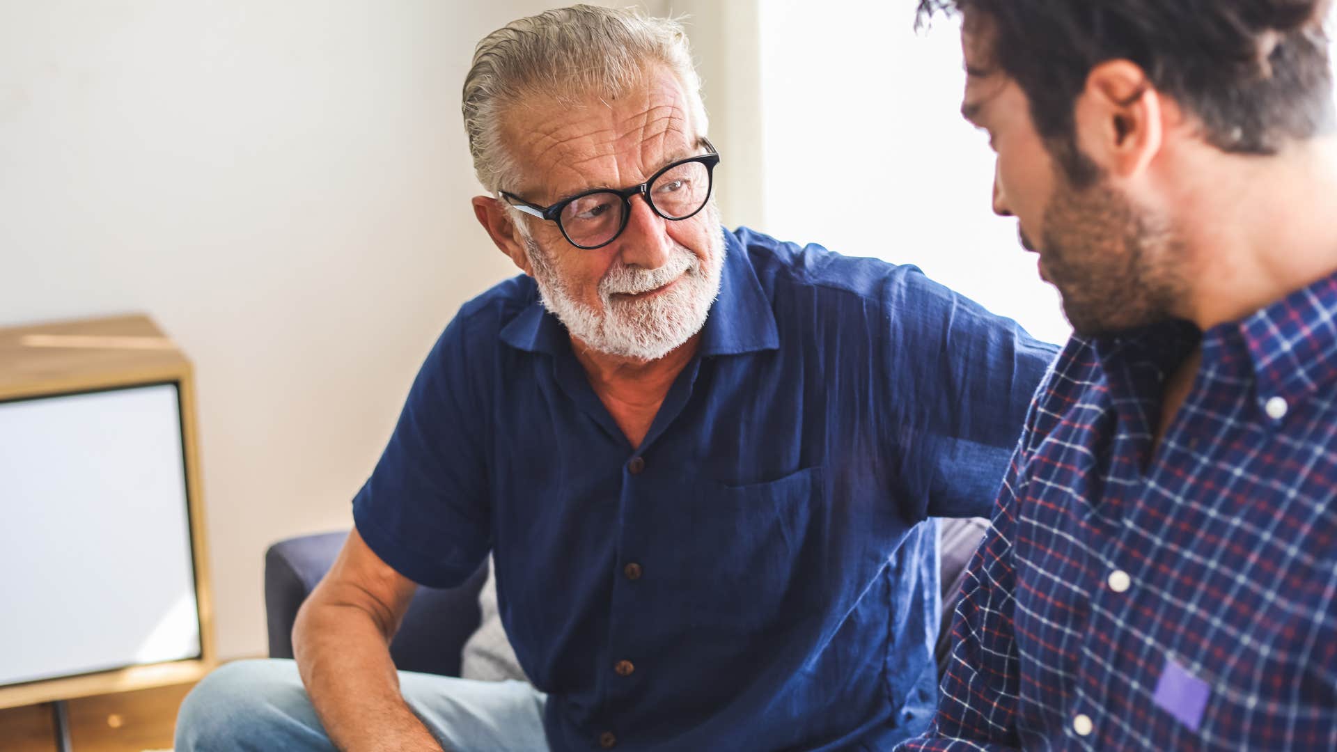 older man with a need for control talking to his adult son