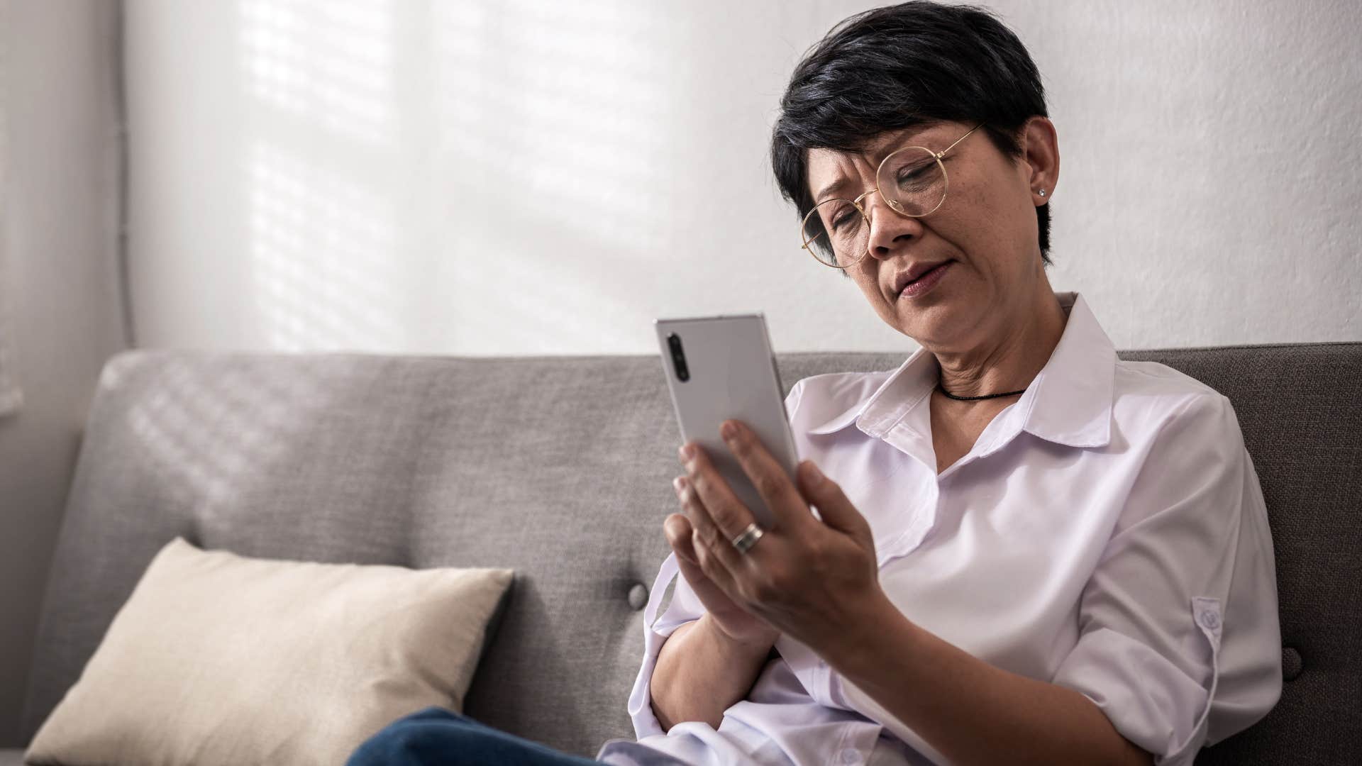 older woman with unrealistic expectations texting to adult child