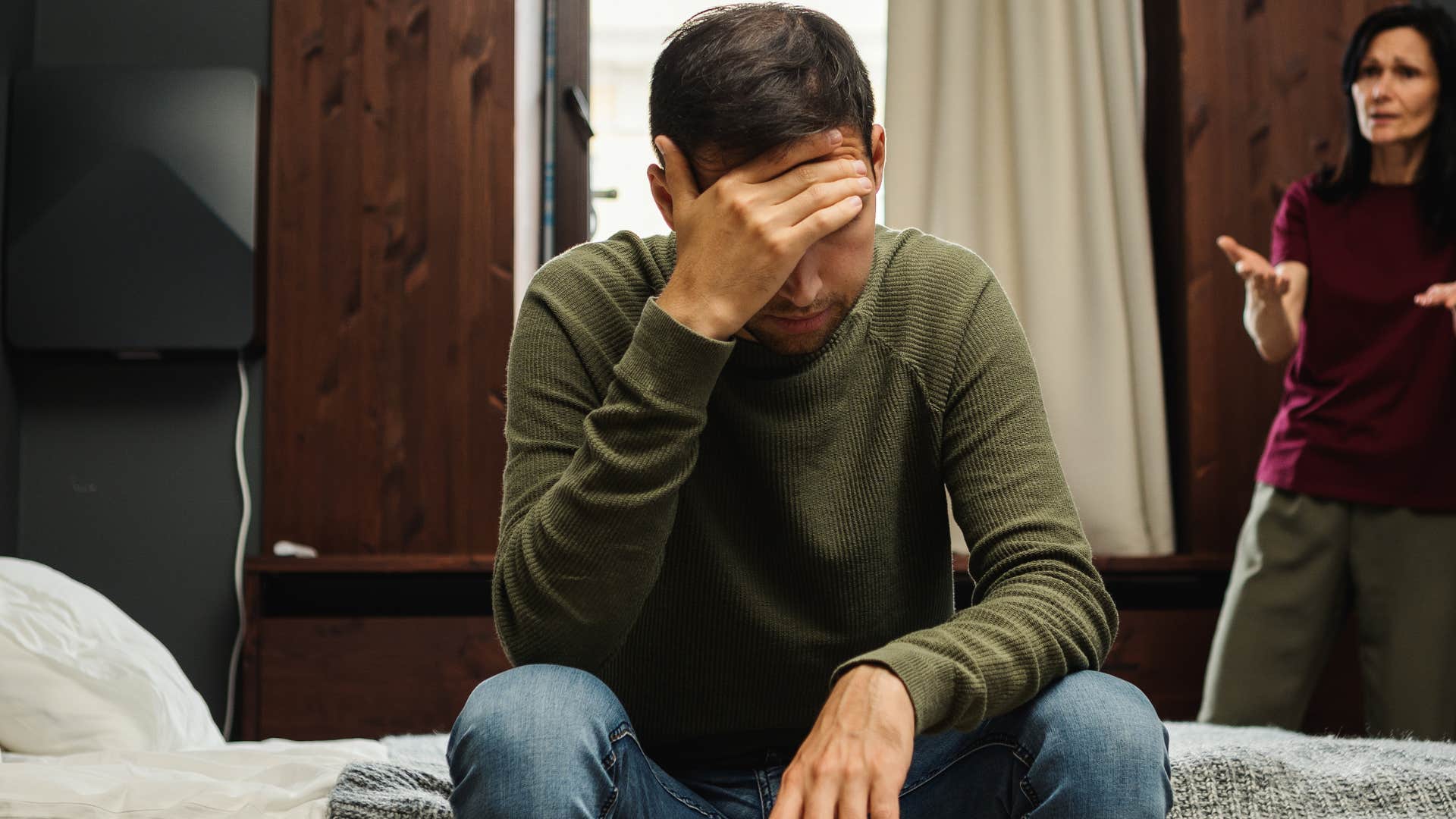 older woman minimizing her upset son's childhood trauma