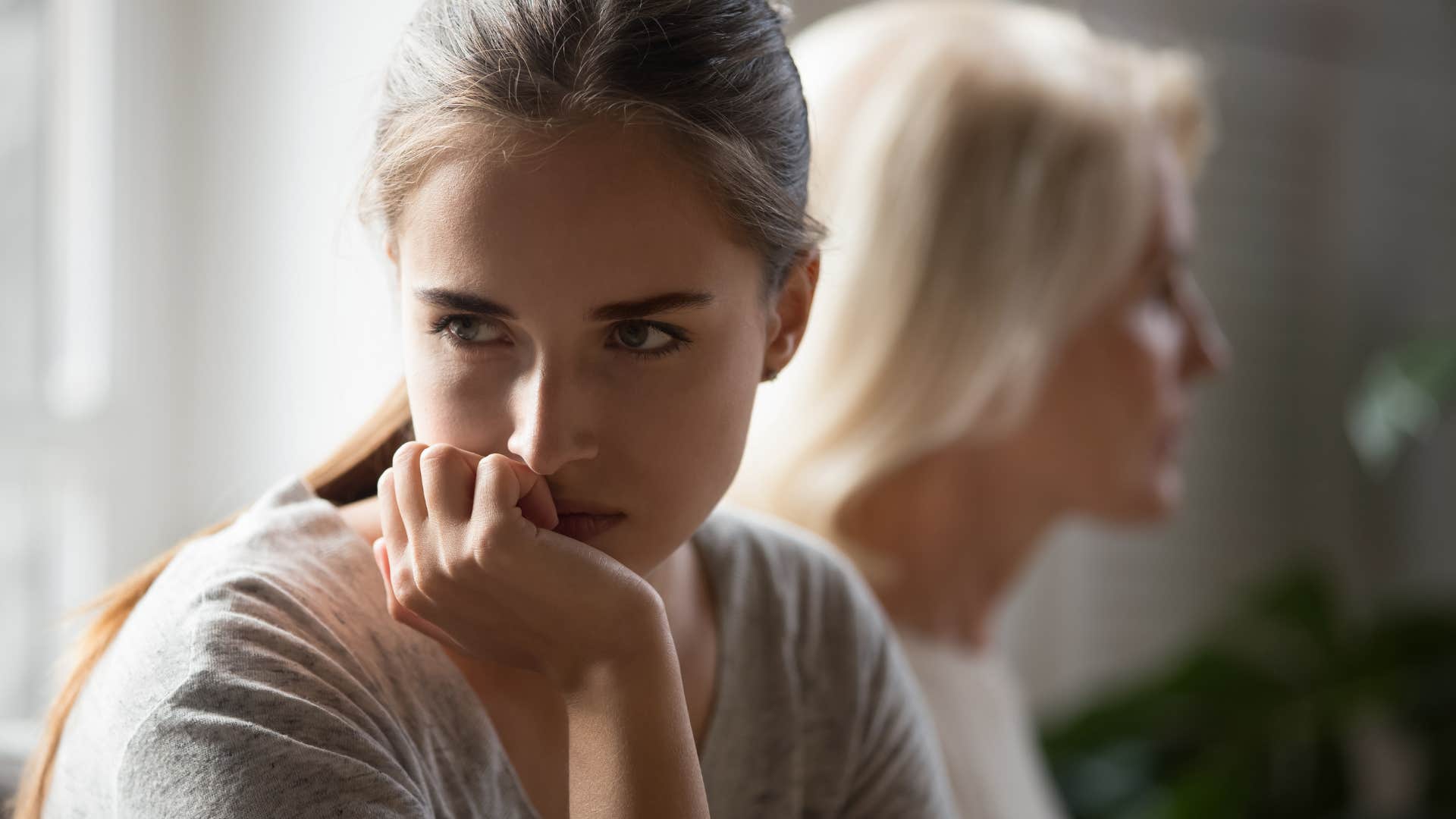 upset woman turned away from mother who has no patience