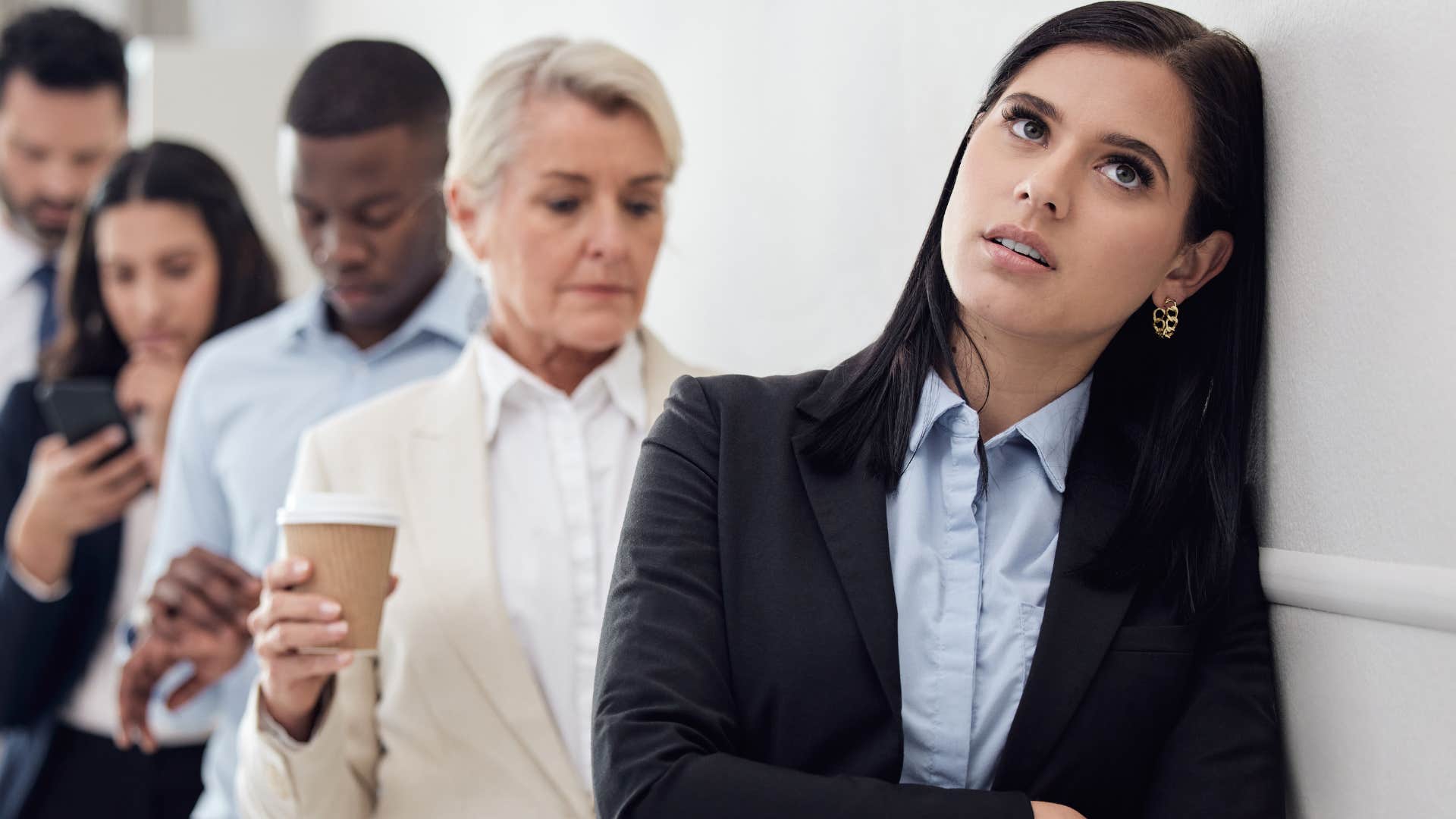 annoyed woman rolling her eyes while waiting in line
