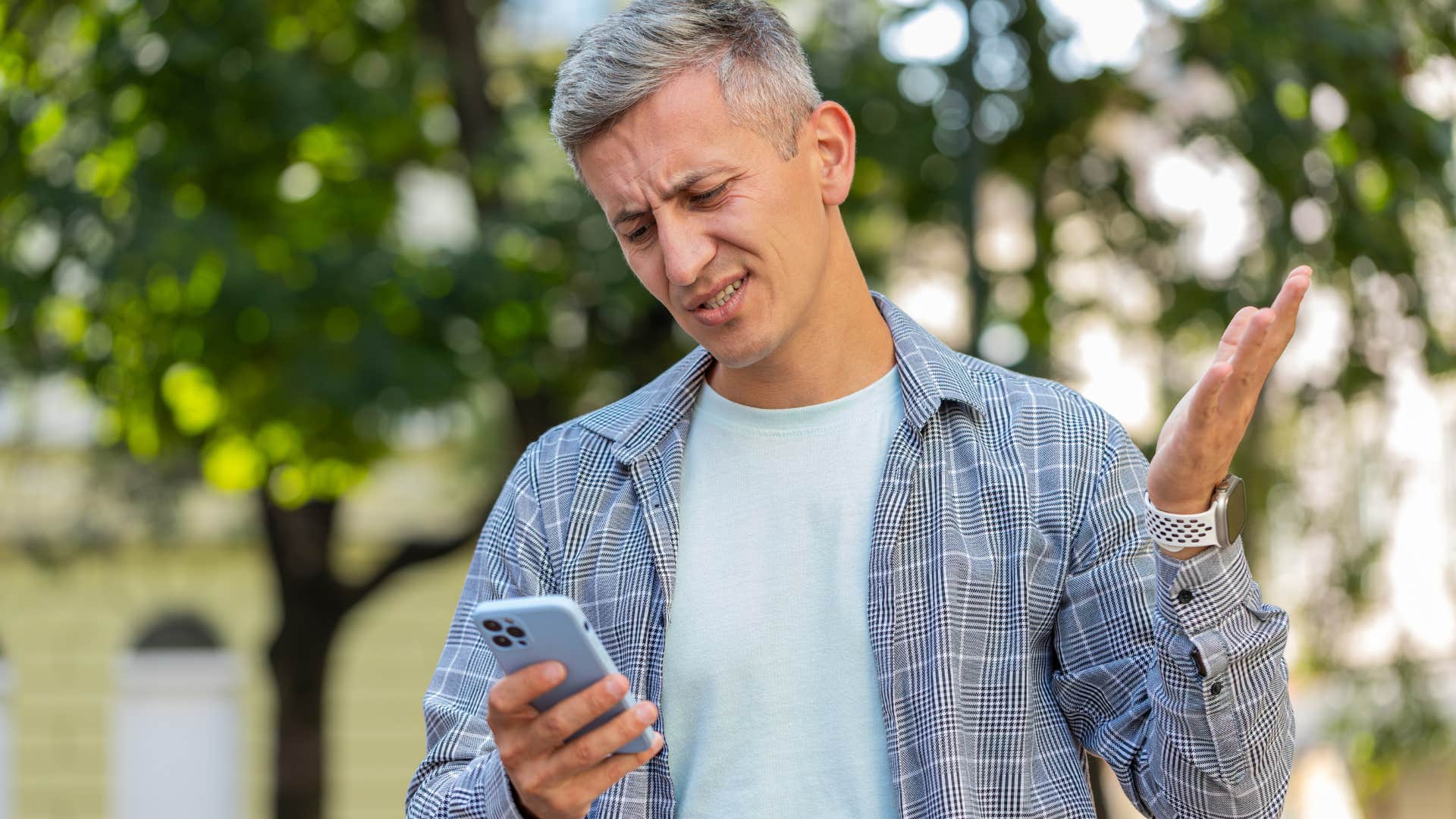 man looking annoyed checking the lottery winners online