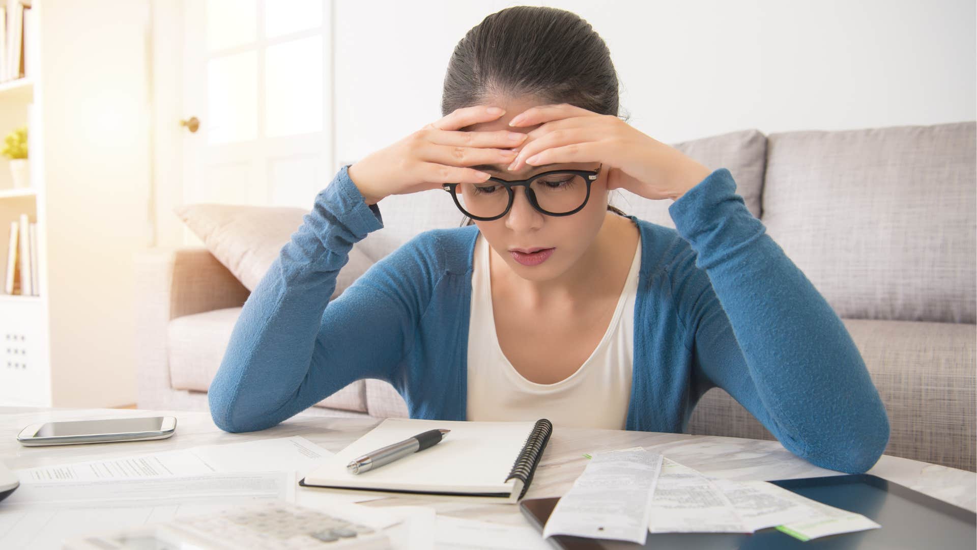  stressed woman paying minimums on credit cards