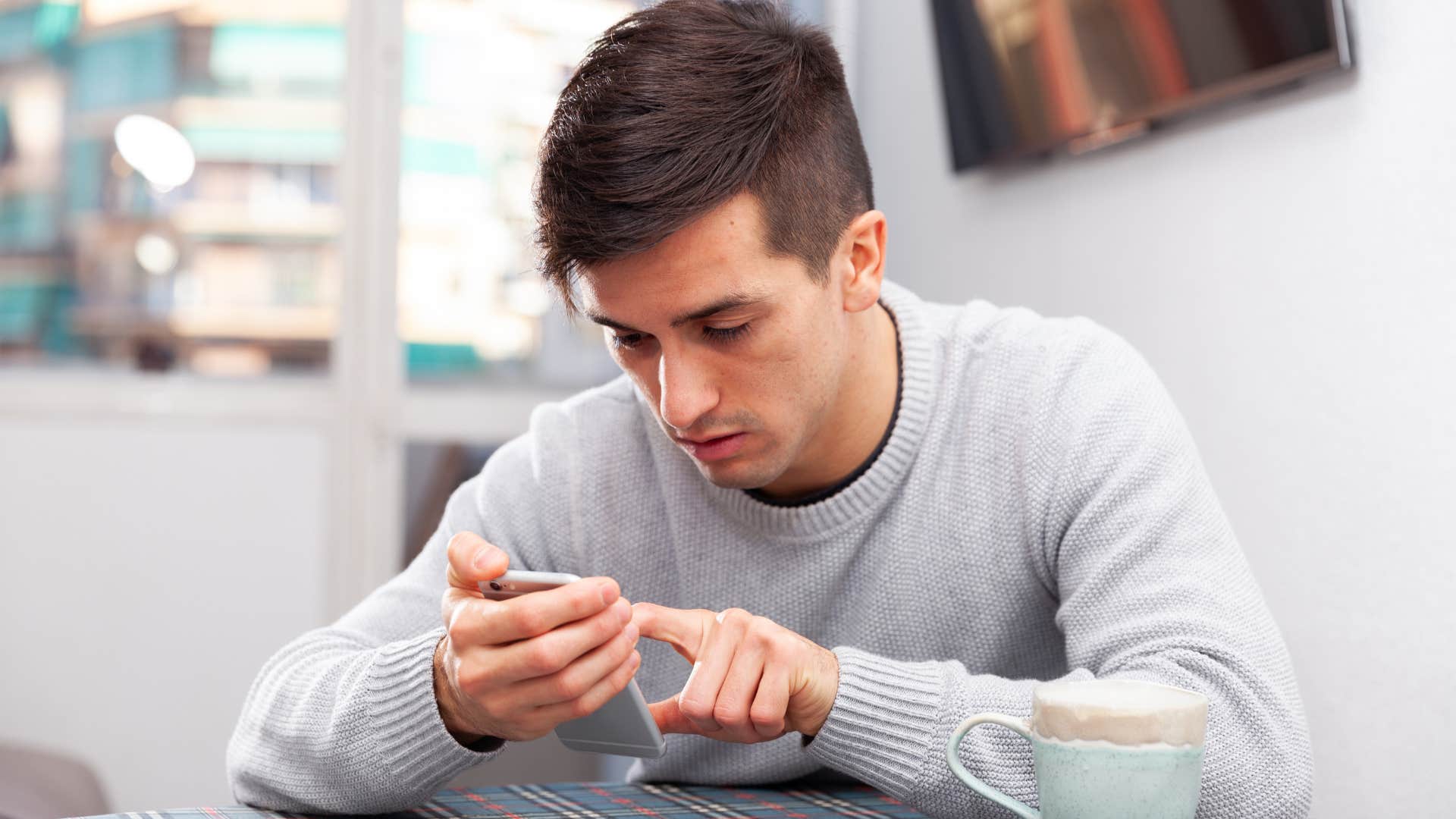 man playing mobile games on his phone